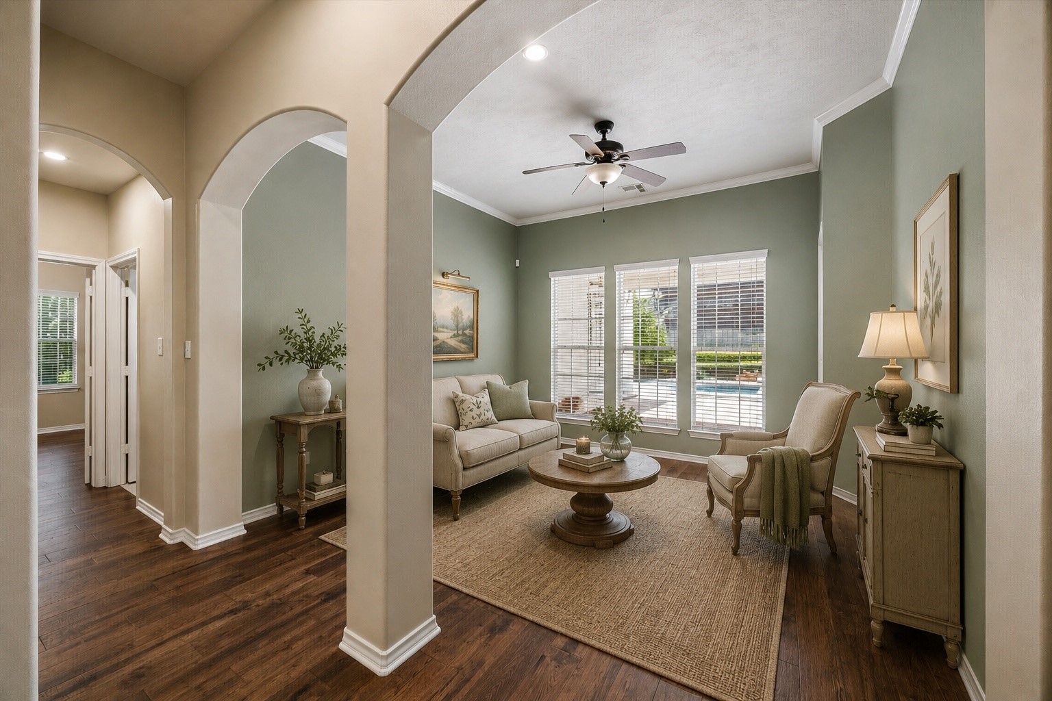 Virtually staged to showcase the homes open, flowing floor plan, with graceful arched openings connecting the main living spaces. High ceilings, engineered hardwood floors, and abundant natural light enhance the spacious feel.