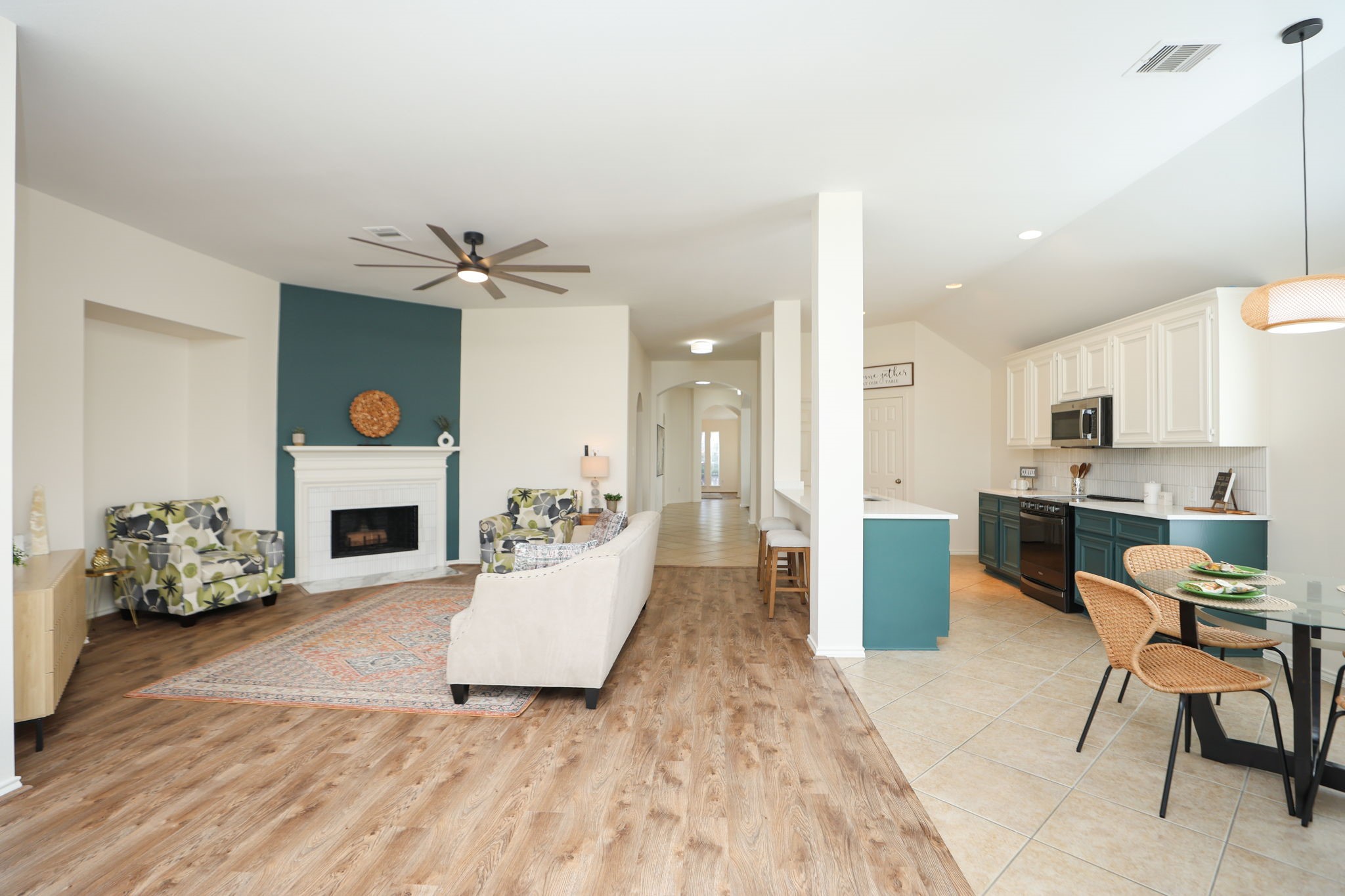 View from the back door showcasing the open kitchen and dining area with grand central hallway back to the front door!