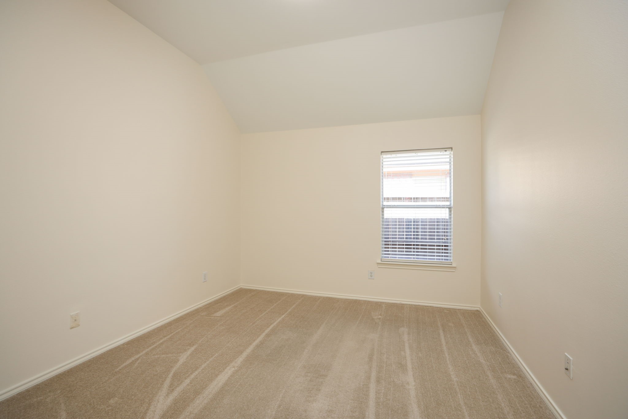 2nd bedroom in this split floor plan home feels very spacious with high ceilings and fresh paint in whole home!