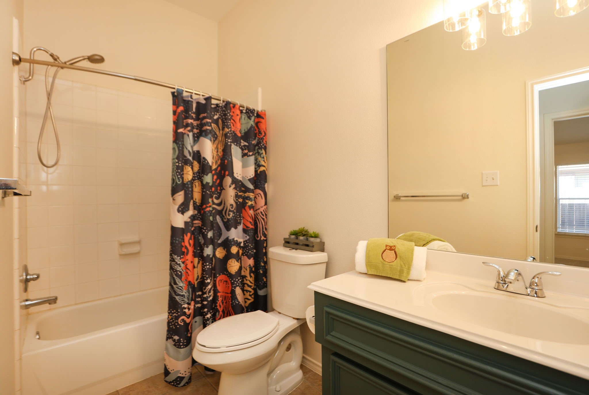 2nd full bath in this split floor plan home. Features painted vanity and neutral tones.