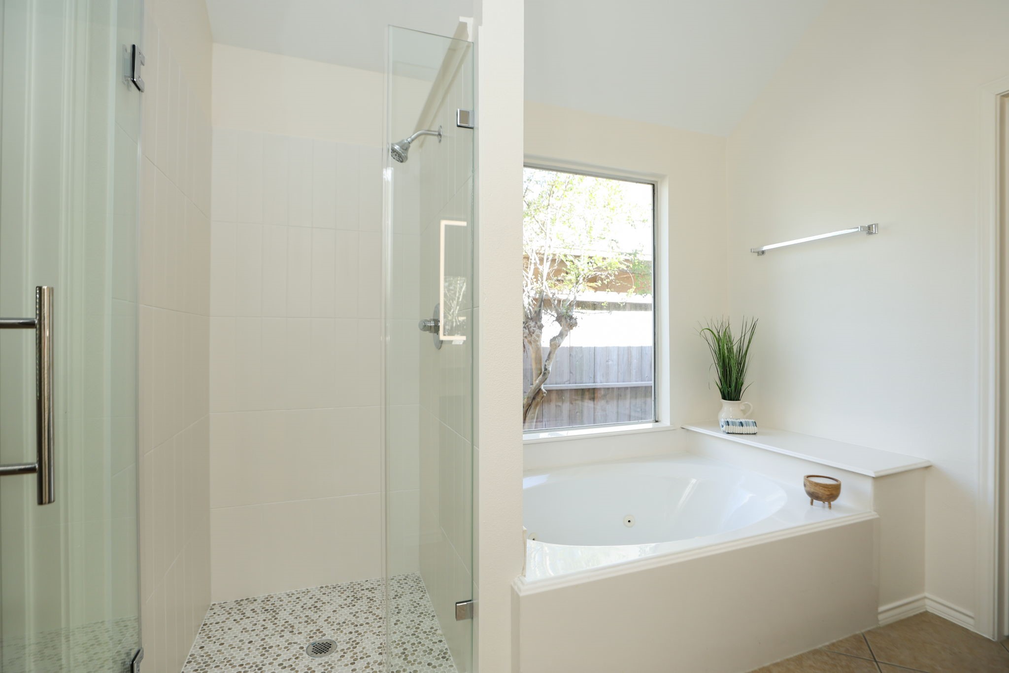 Fabulous primary bath has a brand new shower with seamless glass entry and penny tile floor! Soaking tub for nights in.
