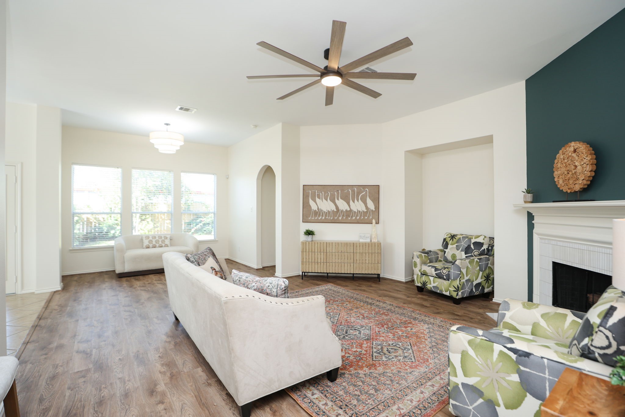 You are greeted with warmth and light as you enter the main living area. Complete with 8 blade fan, high ceilings, and an open floor plan.