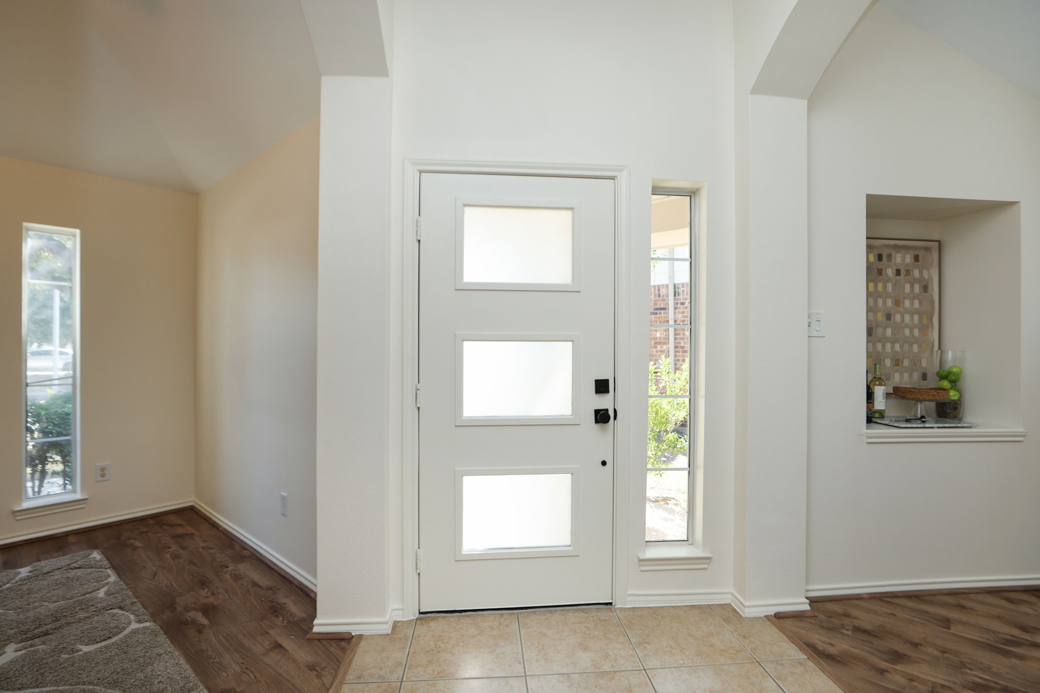 Beautiful new front door with glass panels greets you as soon as you enter the home.