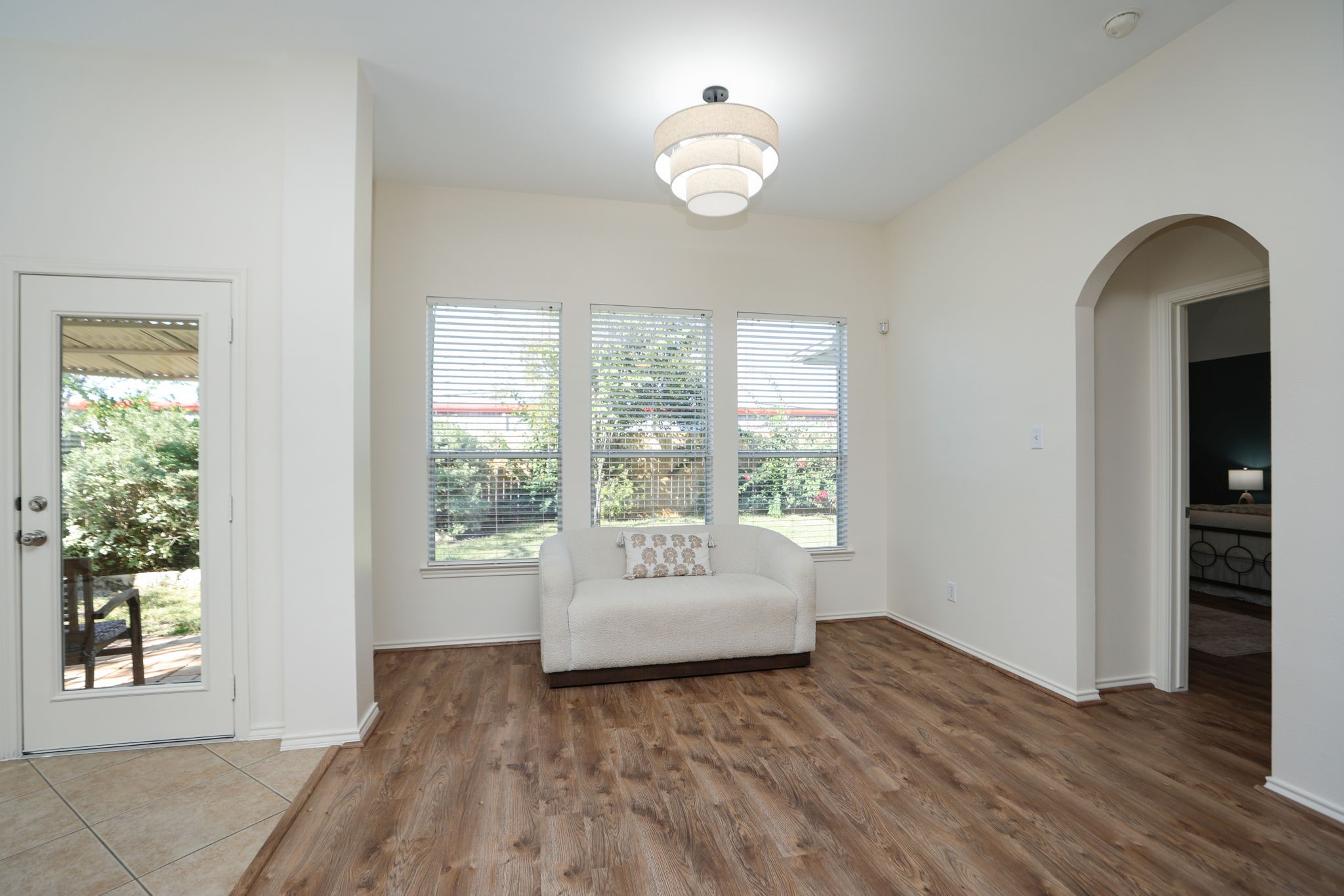 This area can be a play space, dining space, or nook to relax in front of the large windows to your fabulous back yard! Well-lit with new light fixture.
