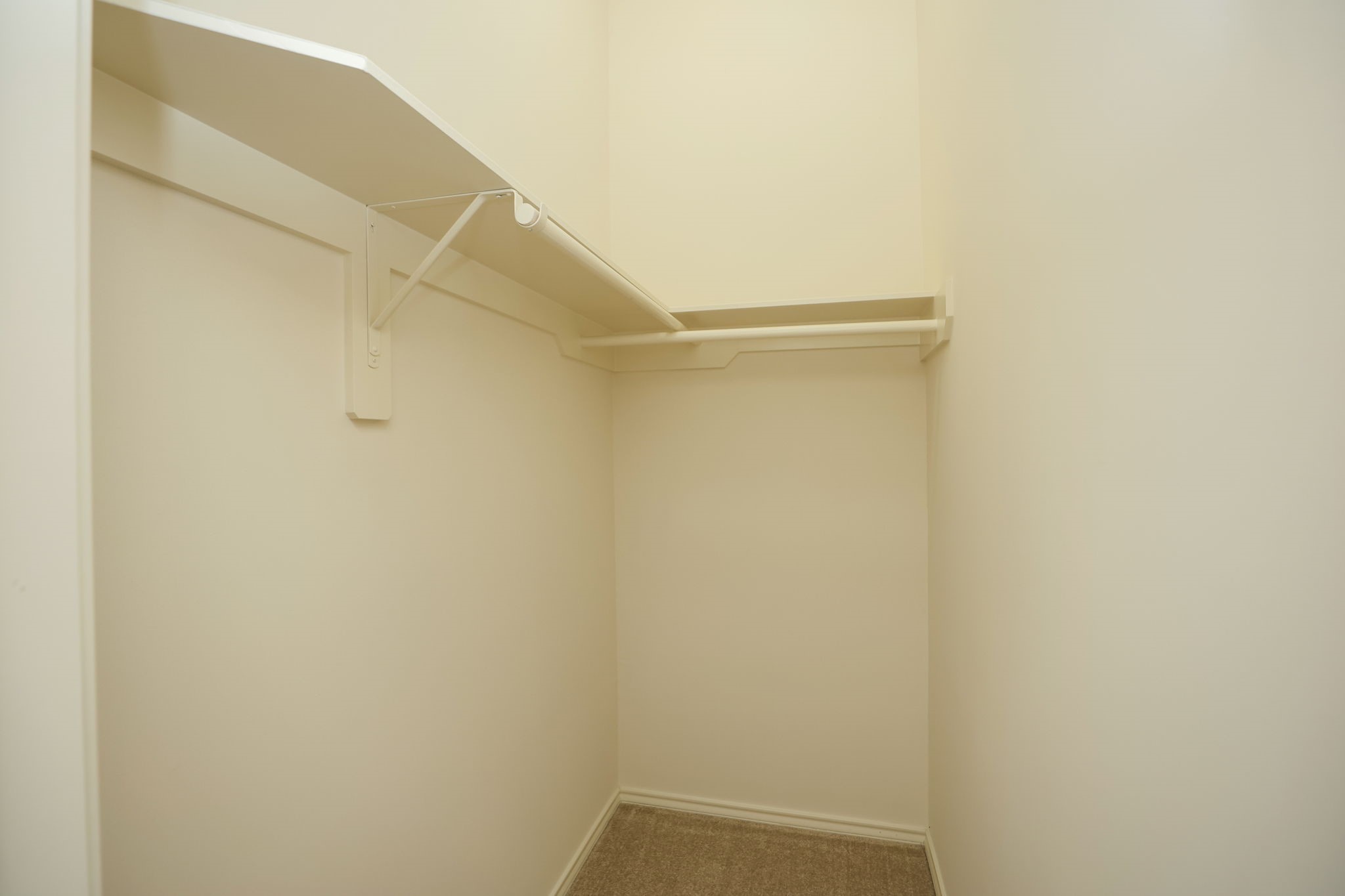 Hallway to the other bedrooms includes this bonus walk-in closet for sports gear, crafting, or additional storage.