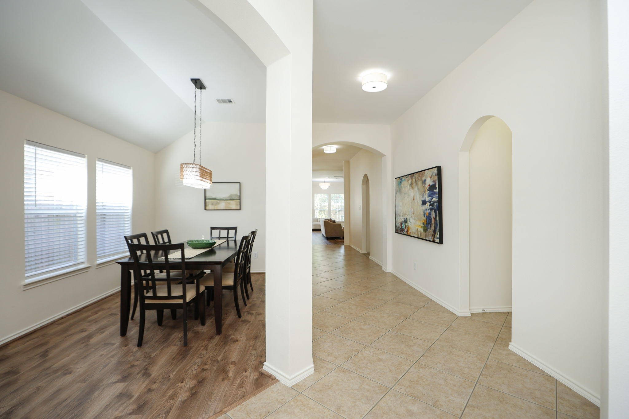 View from the front door showcasing the 6 foot wide central hallway, high ceilings, and modern feel.