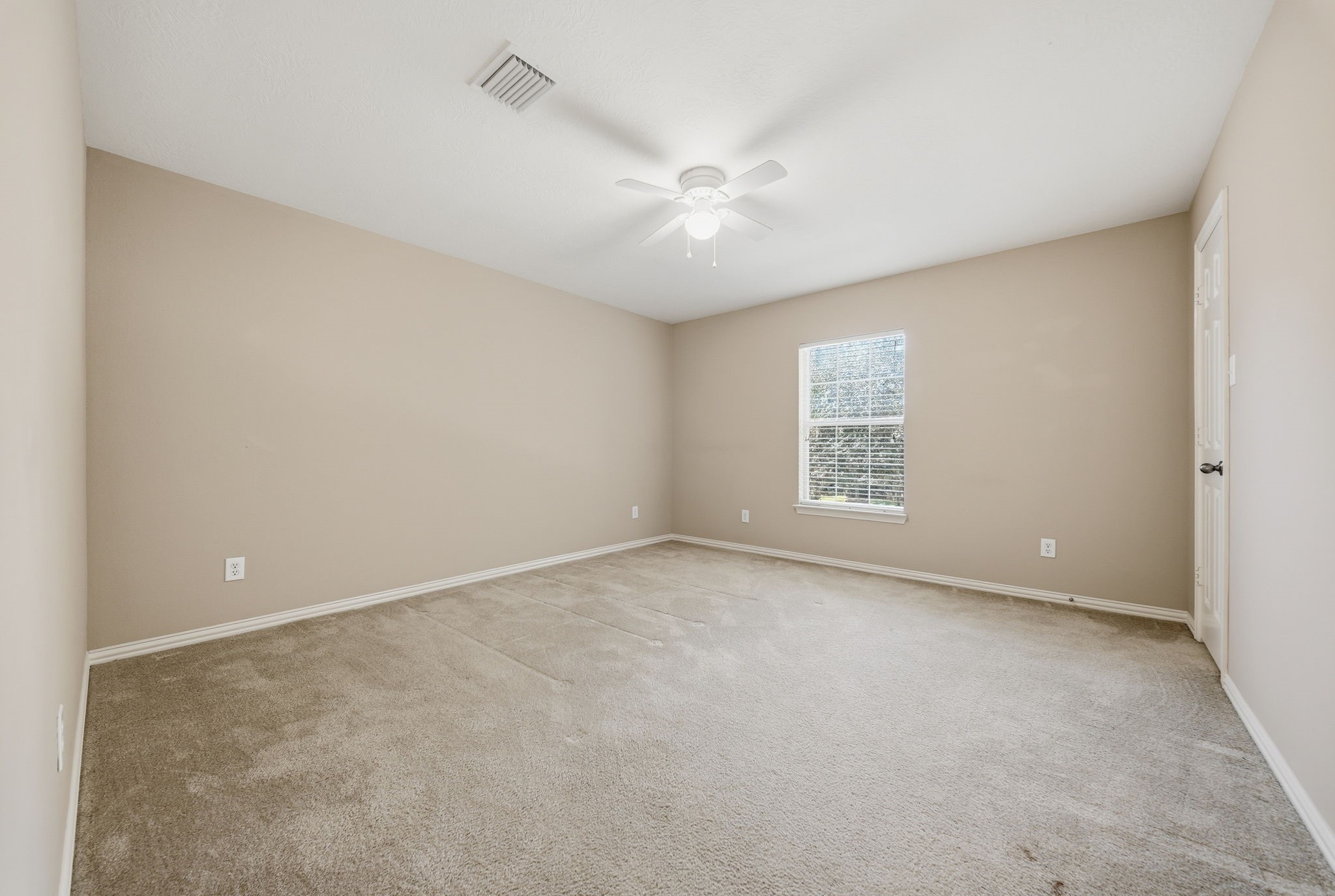 Upstairs Bedroom 4 features a front-facing window that welcomes natural light, offering a comfortable space for a bedroom, guest retreat, or home office.