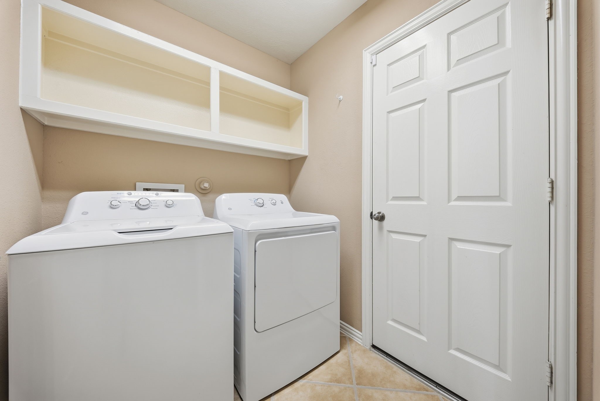 Downstairs laundry room conveniently located off the foyer with direct access to the garage makes daily routines easier.