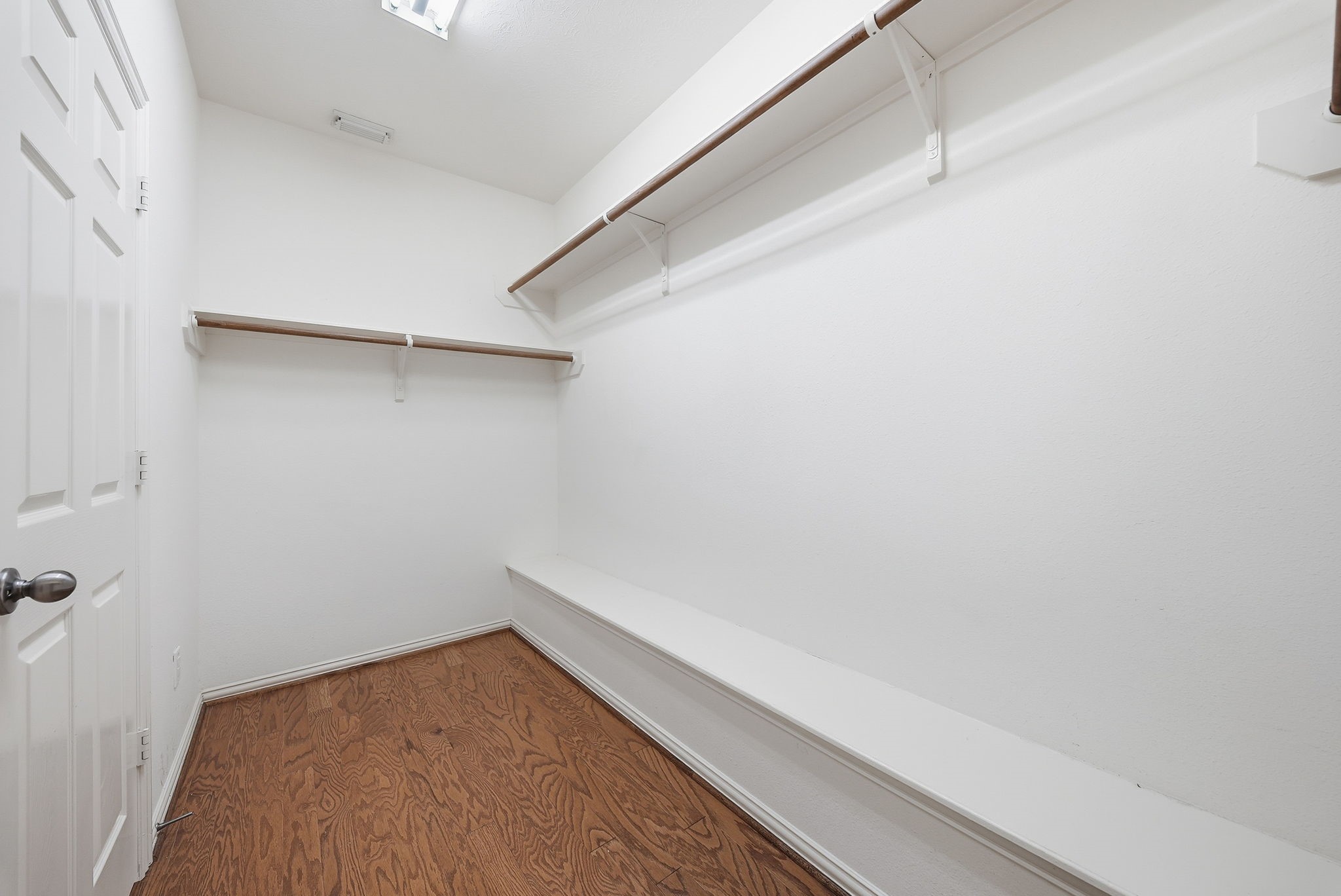 Primary closet offers dedicated space to keep clothing, shoes, and accessories organized and within easy reach.