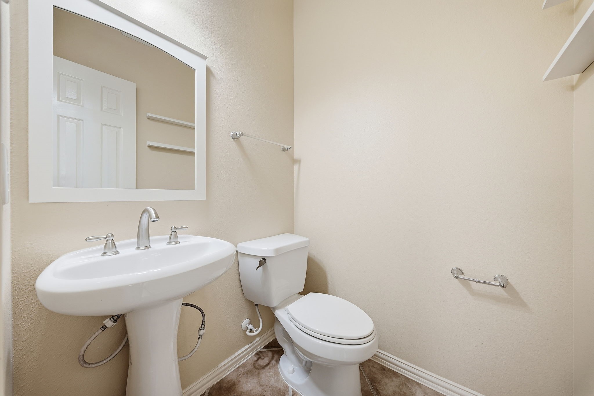 Downstairs half bath conveniently located off the foyer provides easy access for guests when entertaining.