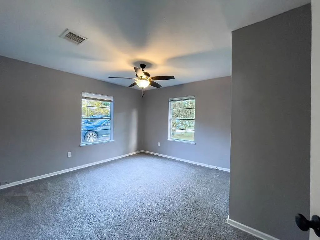Bedroom with Ceiling Fan and Neutral Paint