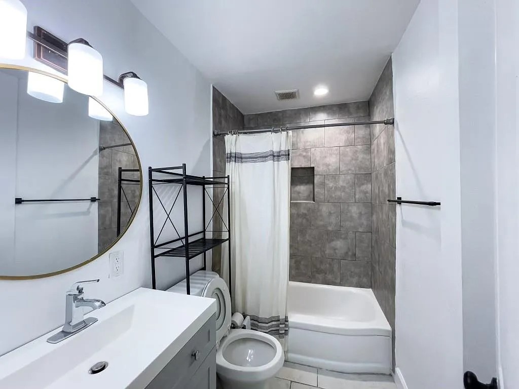 Updated Bathroom with Modern Vanity and Mirror