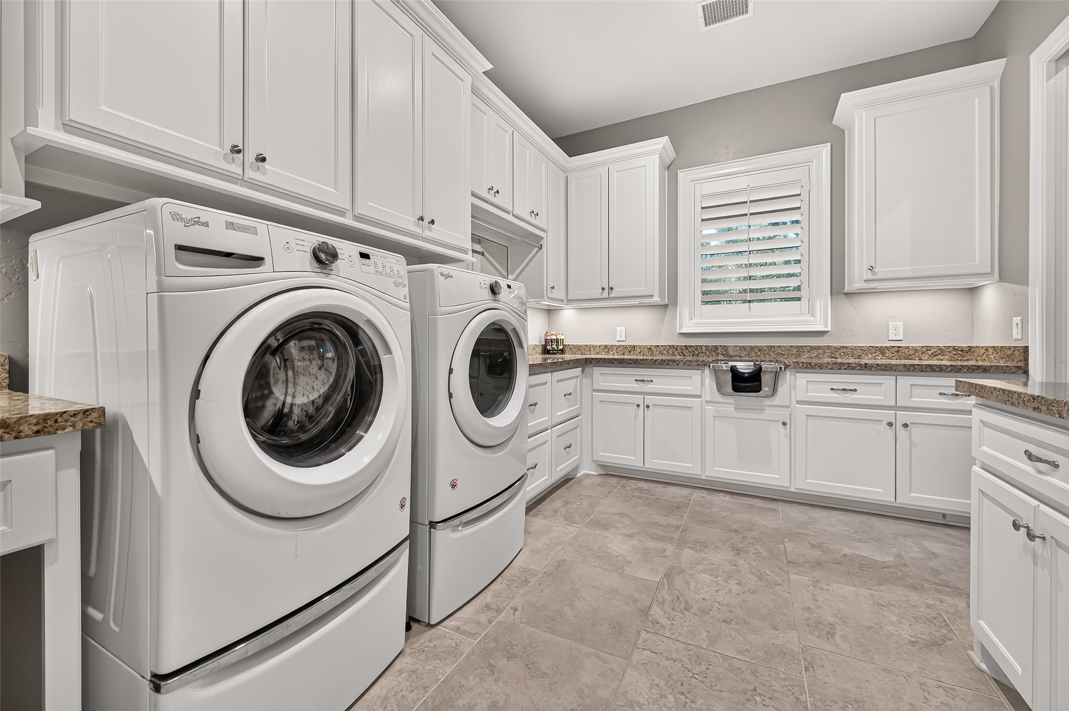 Huge laundry room located just off one of the primary closets.