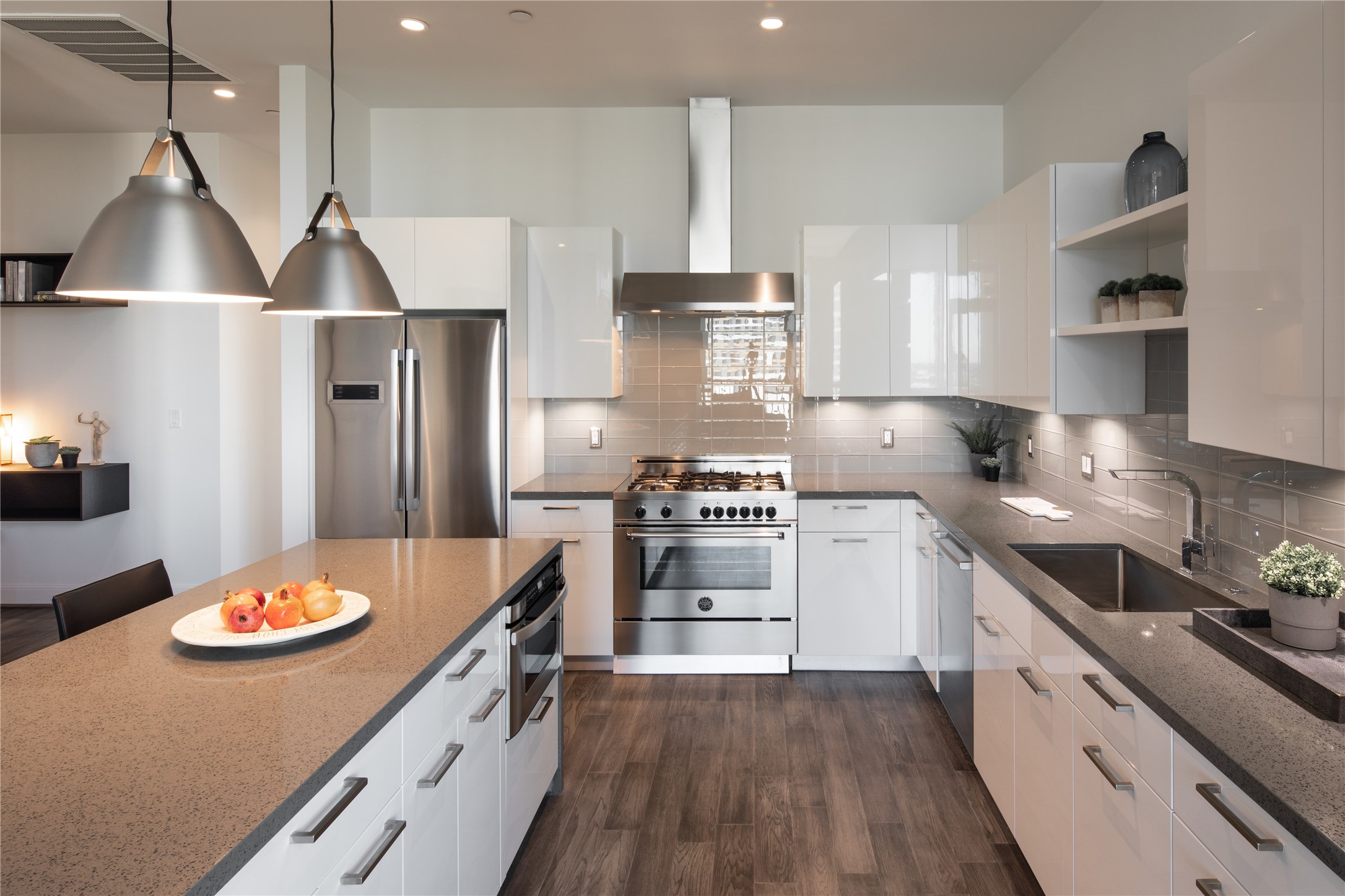 [Kitchen] Equipped with Bertazzoni oven and venthood, Thermador and Bosch appliances, and a large stainless steel sink with designer faucet