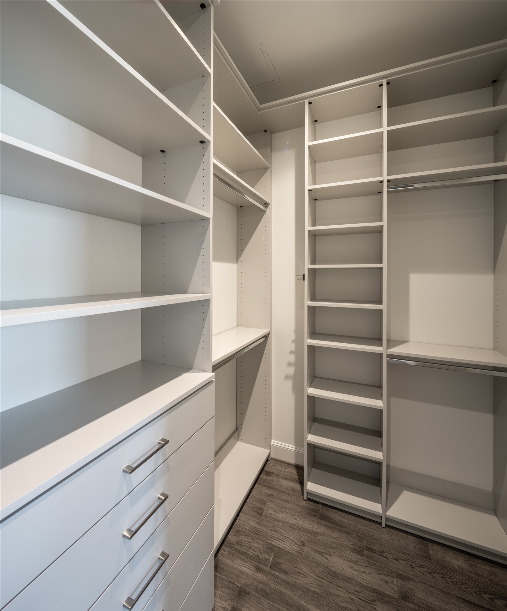 [Primary Dressing Room] Handsomely designed and highly functional custom closet installation with ample drawer and hanging space