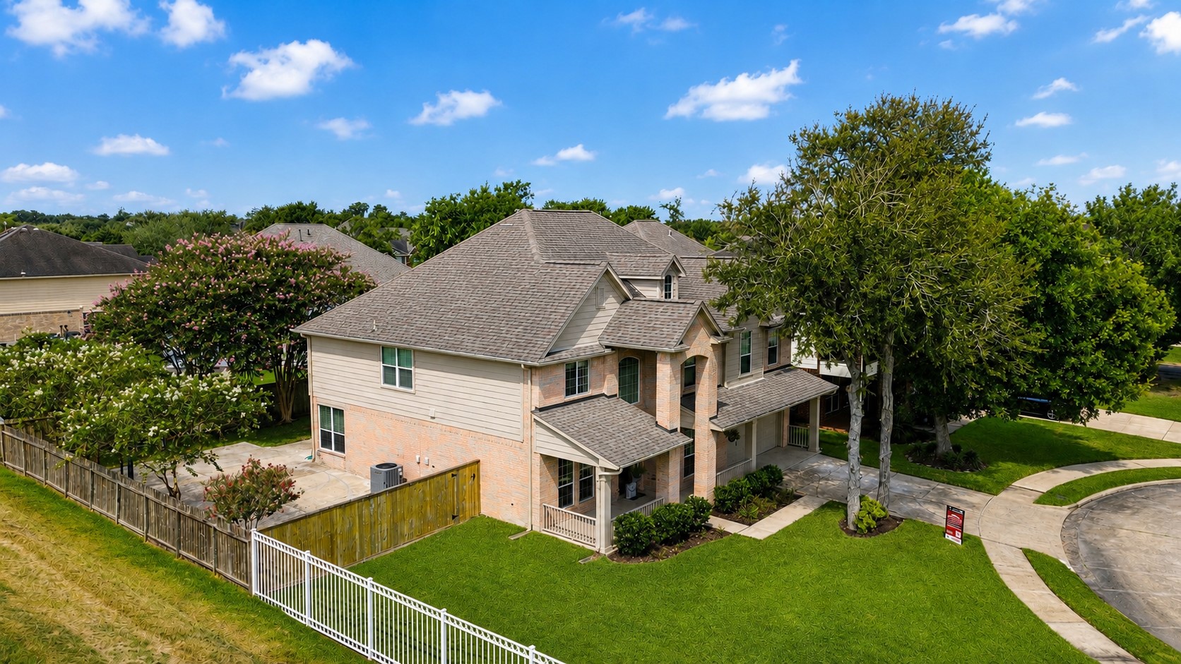 AERIAL VIEW HIGHLIGHTS THE HOMES IMPRESSIVE TWO-STORY ELEVATION, LARGE LOT, MATURE LANDSCAPING, AND QUIET CUL-DE-SAC SETTING.