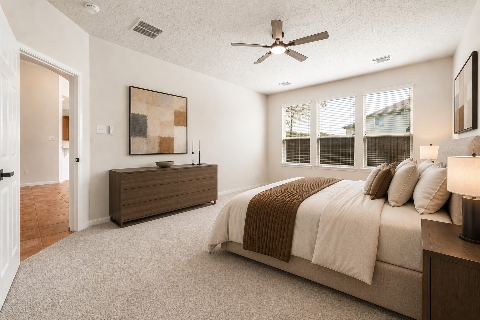 SPACIOUS PRIMARY BEDROOM WITH THREE LARGE WINDOWS, HIGH CEILINGS, AND ABUNDANT NATURAL LIGHT. *Virtually staged.