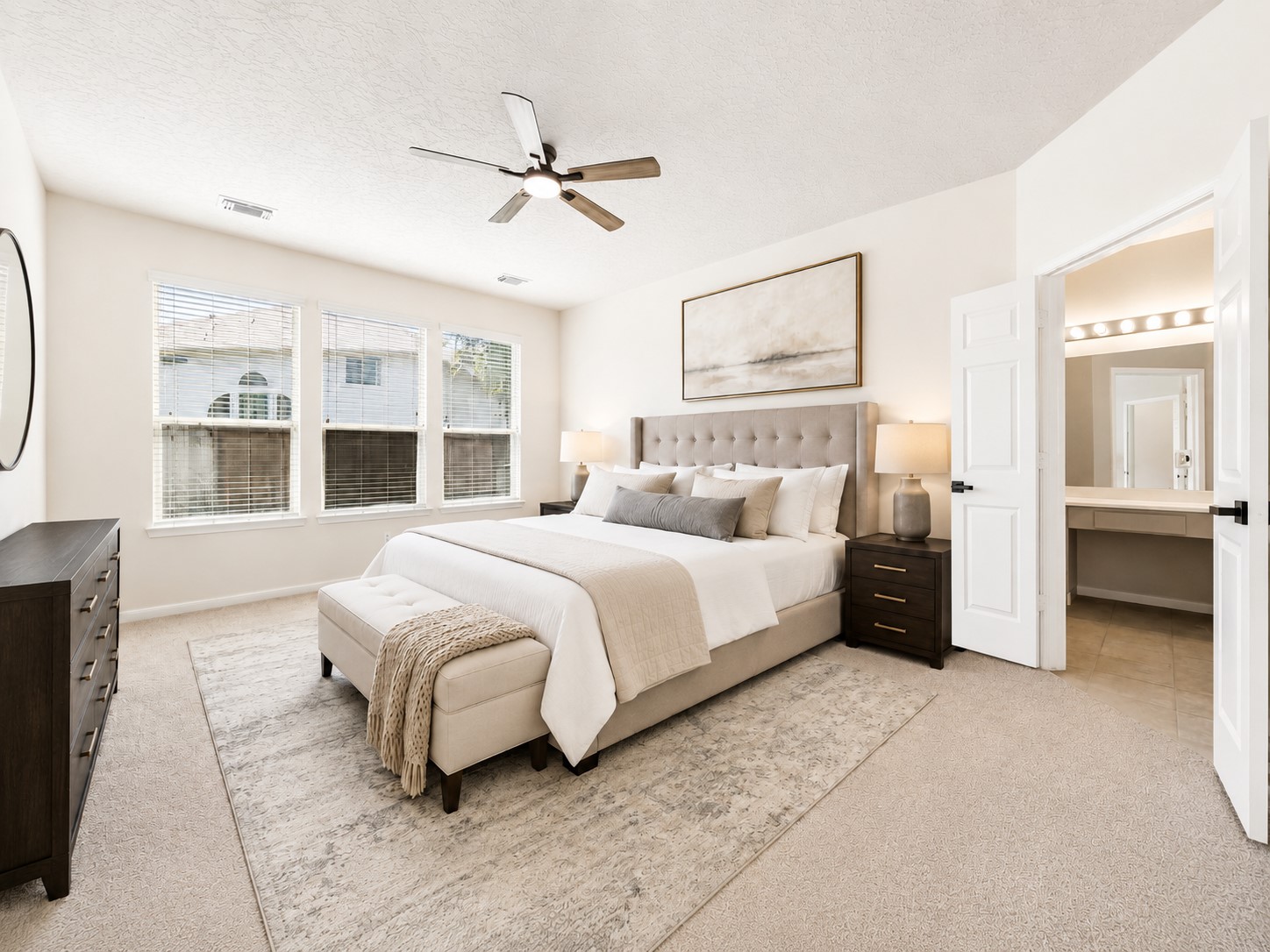 ANOTHER VIEW OF THE PRIMARY BEDROOM HIGHLIGHTS ITS IMPRESSIVE SIZE AND DIRECT ACCESS TO THE EN-SUITE BATH.