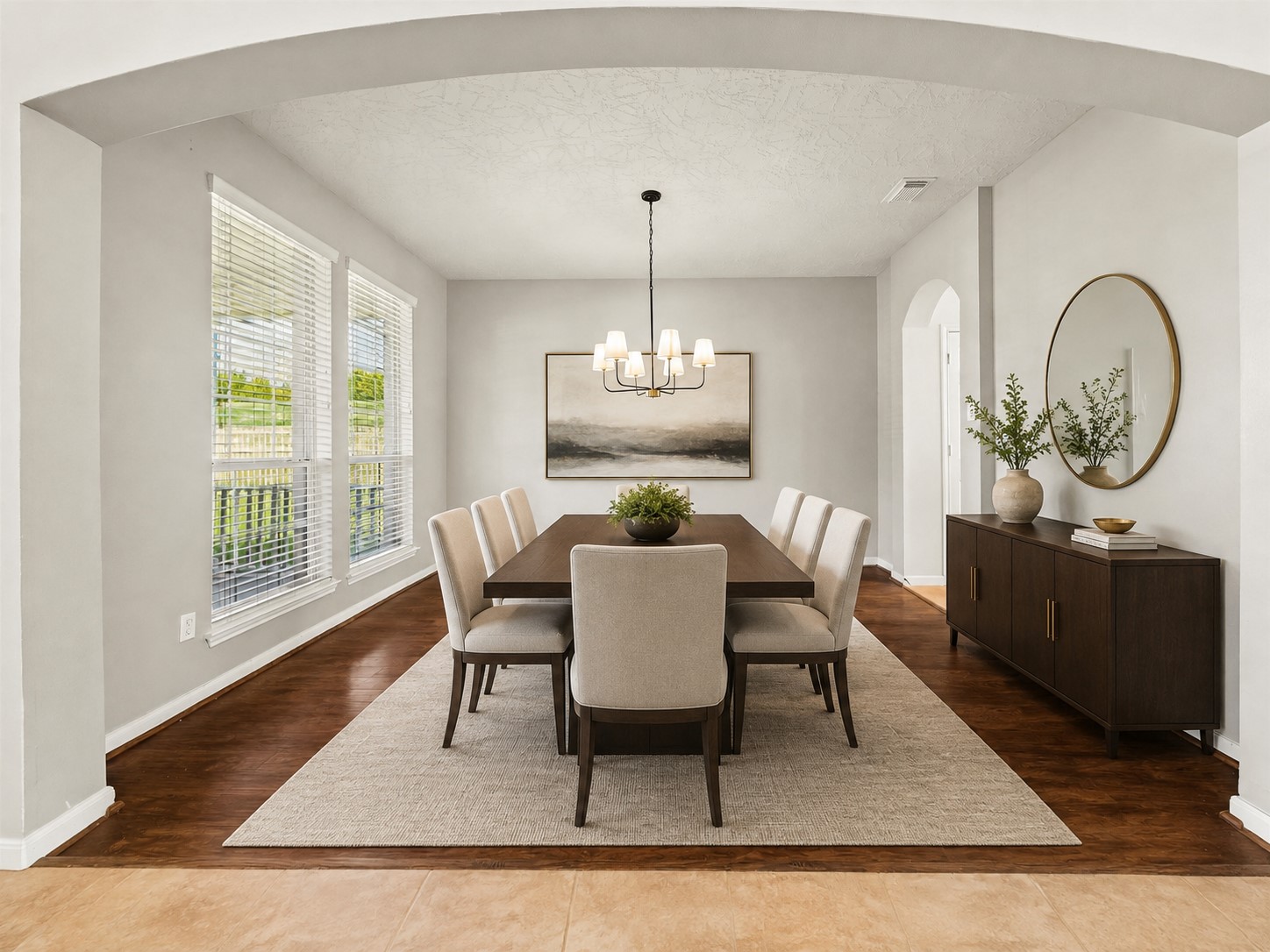 SPACIOUS FORMAL DINING ROOM WITH RICH WOOD FLOORING, OVERSIZED WINDOWS, AND AN ELEGANT ARCHED OPENING. THE GENEROUS DIMENSIONS PROVIDE PLENTY OF ROOM FOR LARGE-SCALE ENTERTAINING. *Virtually staged.