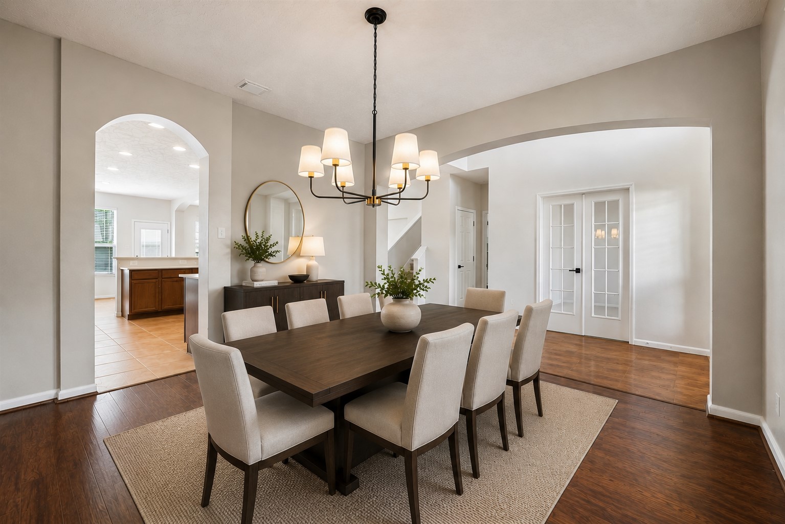 AN ADDITIONAL VIEW OF THE FORMAL DINING SPACE HIGHLIGHTS THE WIDE ARCHWAYS AND OPEN CONNECTION TO THE FOYER AND KITCHEN.