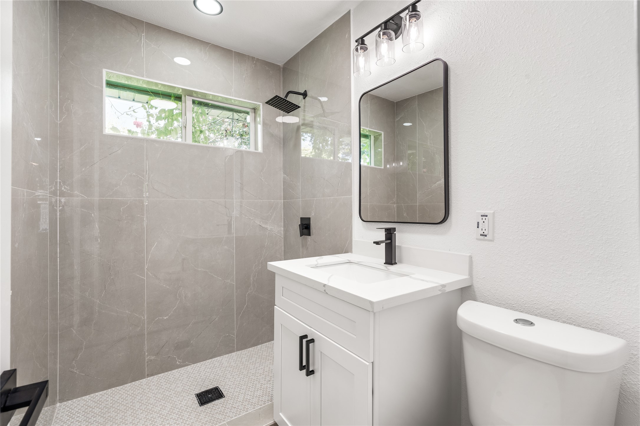 Sophisticated bathroom showcasing timeless tilework, sleek modern fixtures, and a bright, spa-inspired ambiance.
