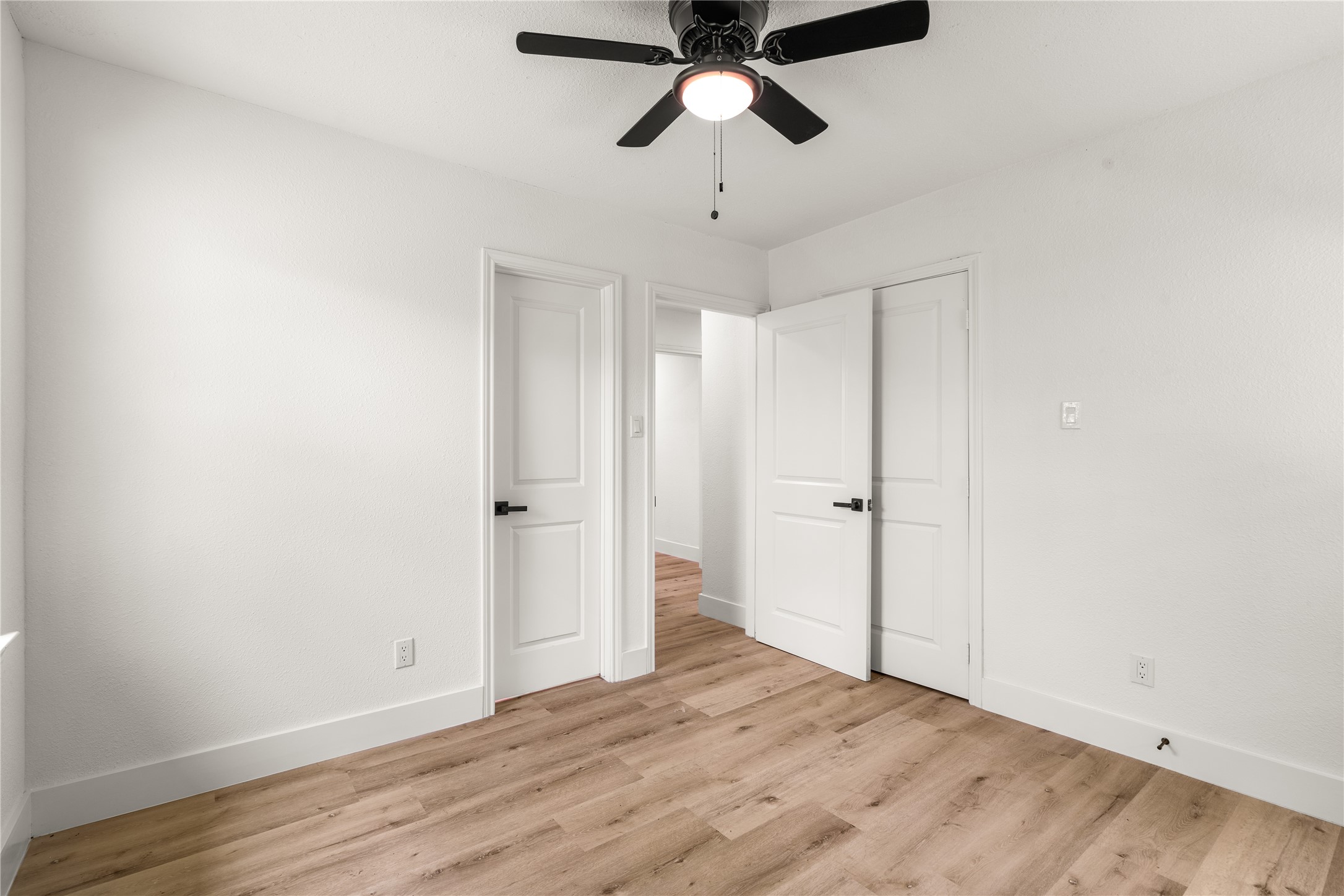 Bright and inviting bedroom featuring generous closet space, abundant natural light, and a soothing neutral palette.