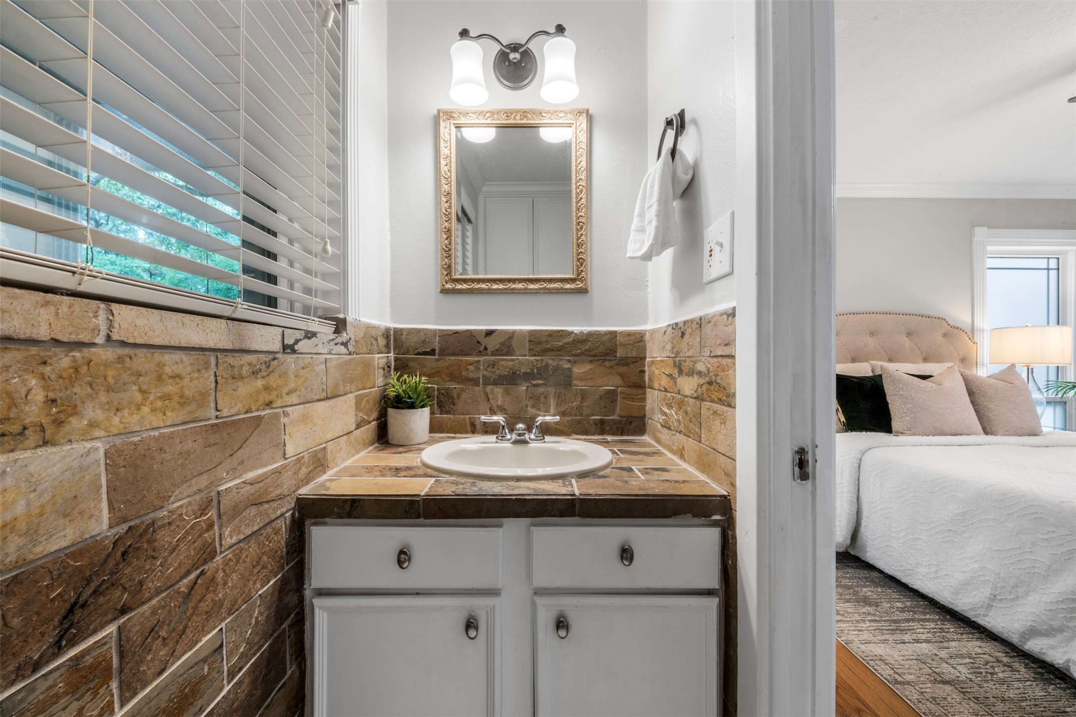 Your primary bathroom has been updated with rich tones and modern finishes.