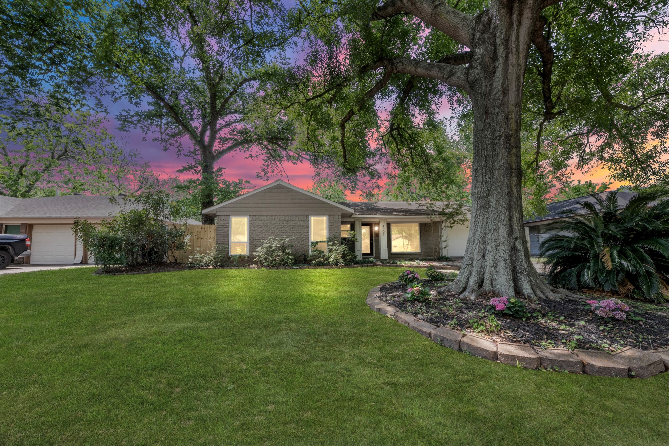 Mature Oak trees canvas the home and the street, providing shade and scenery.