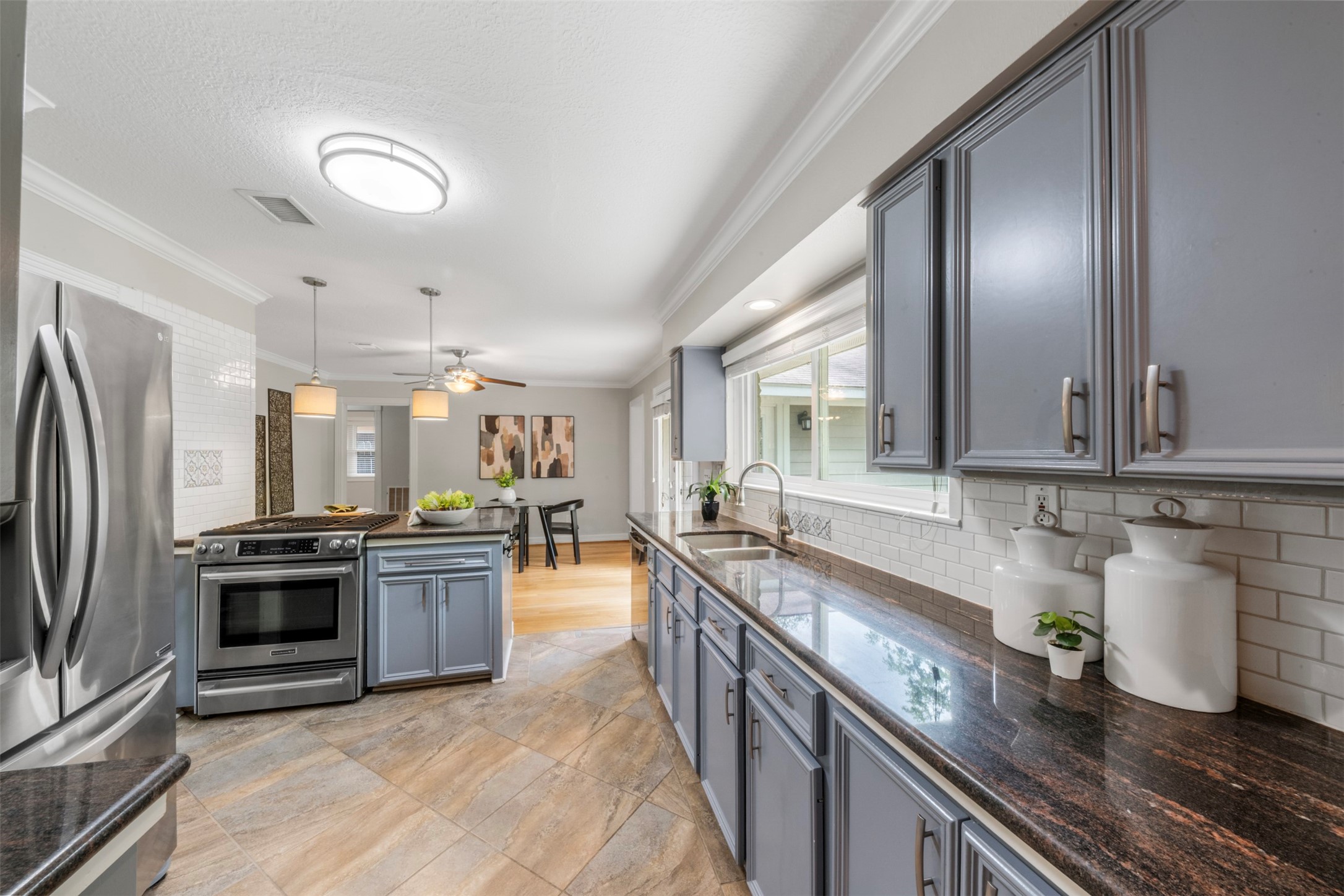 Sleek granite countertops, rich colors, and natural light give this home a cozy yet luxurious feel.