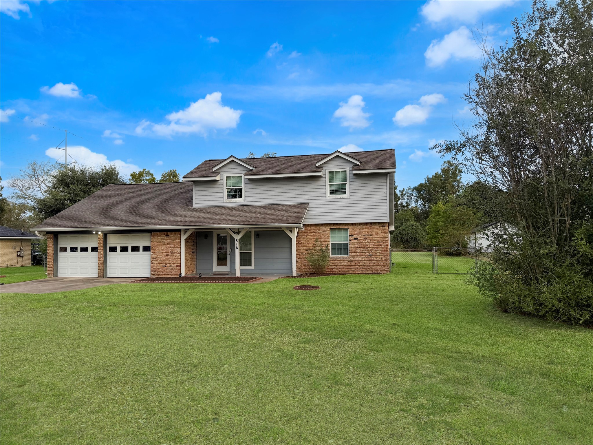 Charming two-story home featuring a small covered front porch, welcoming entryway, and appealing exterior design