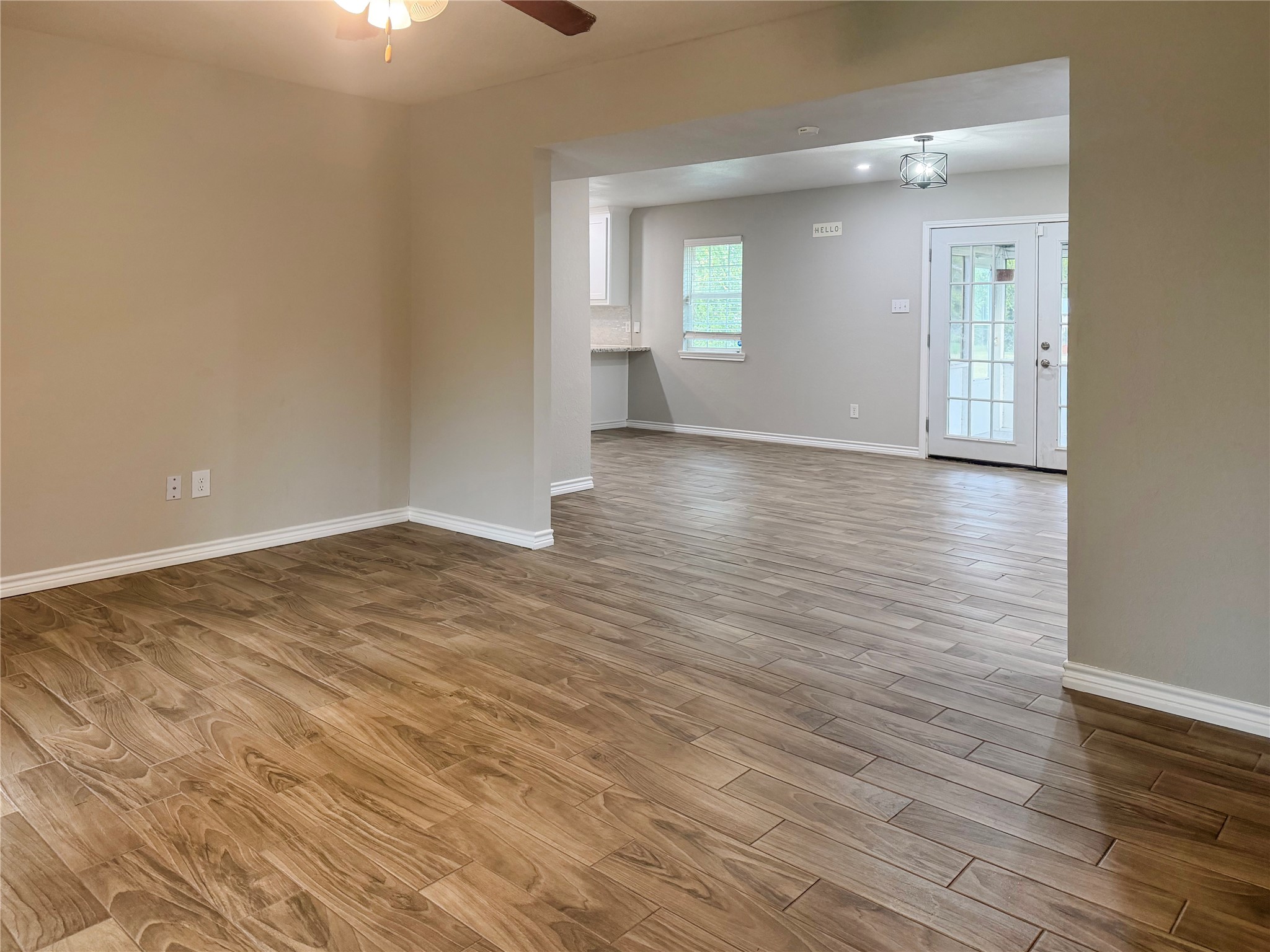 Living room flows seamlessly into the open dining area, creating an inviting layout with easy access between living and dining spaces.