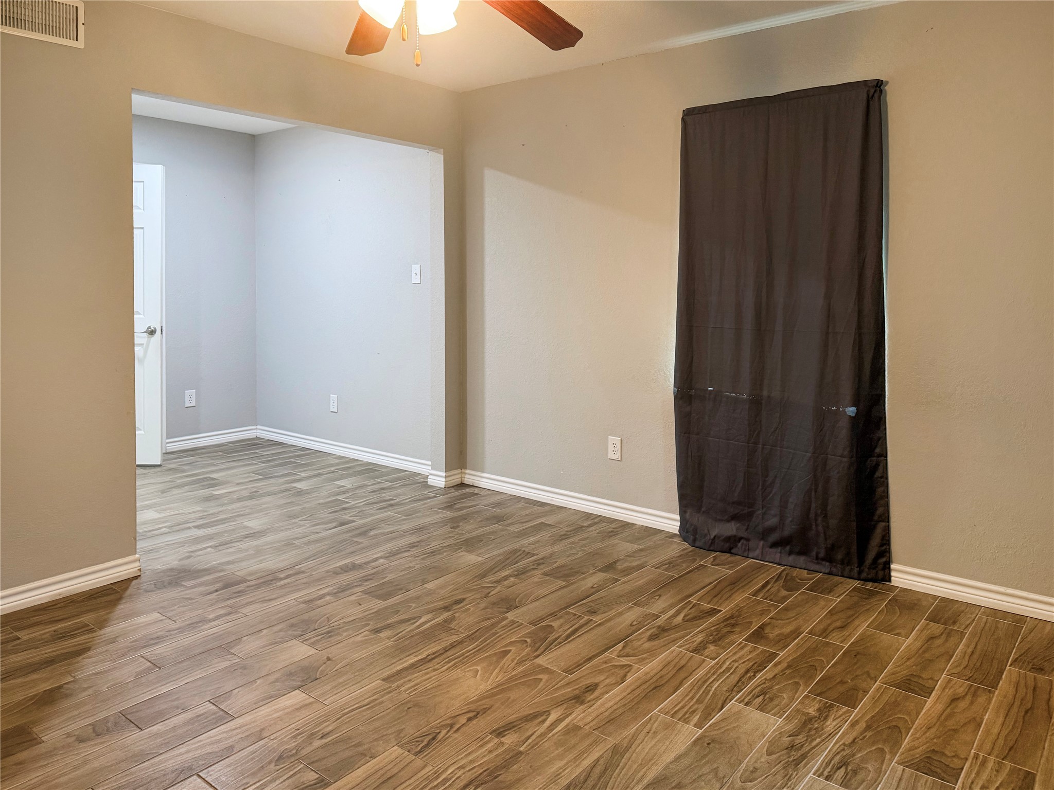 Primary bedroom features a cozy sitting area, offering additional space for relaxing, reading, or unwinding.