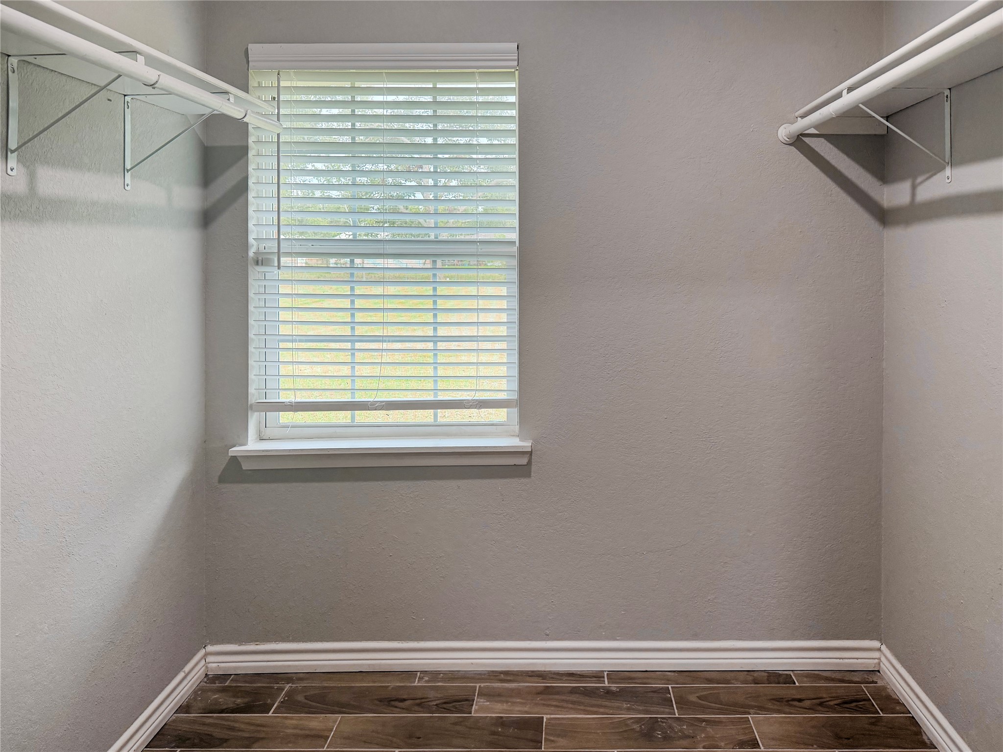 Primary bedroom features a spacious closet, providing ample room for clothing, shoes, and additional storage.