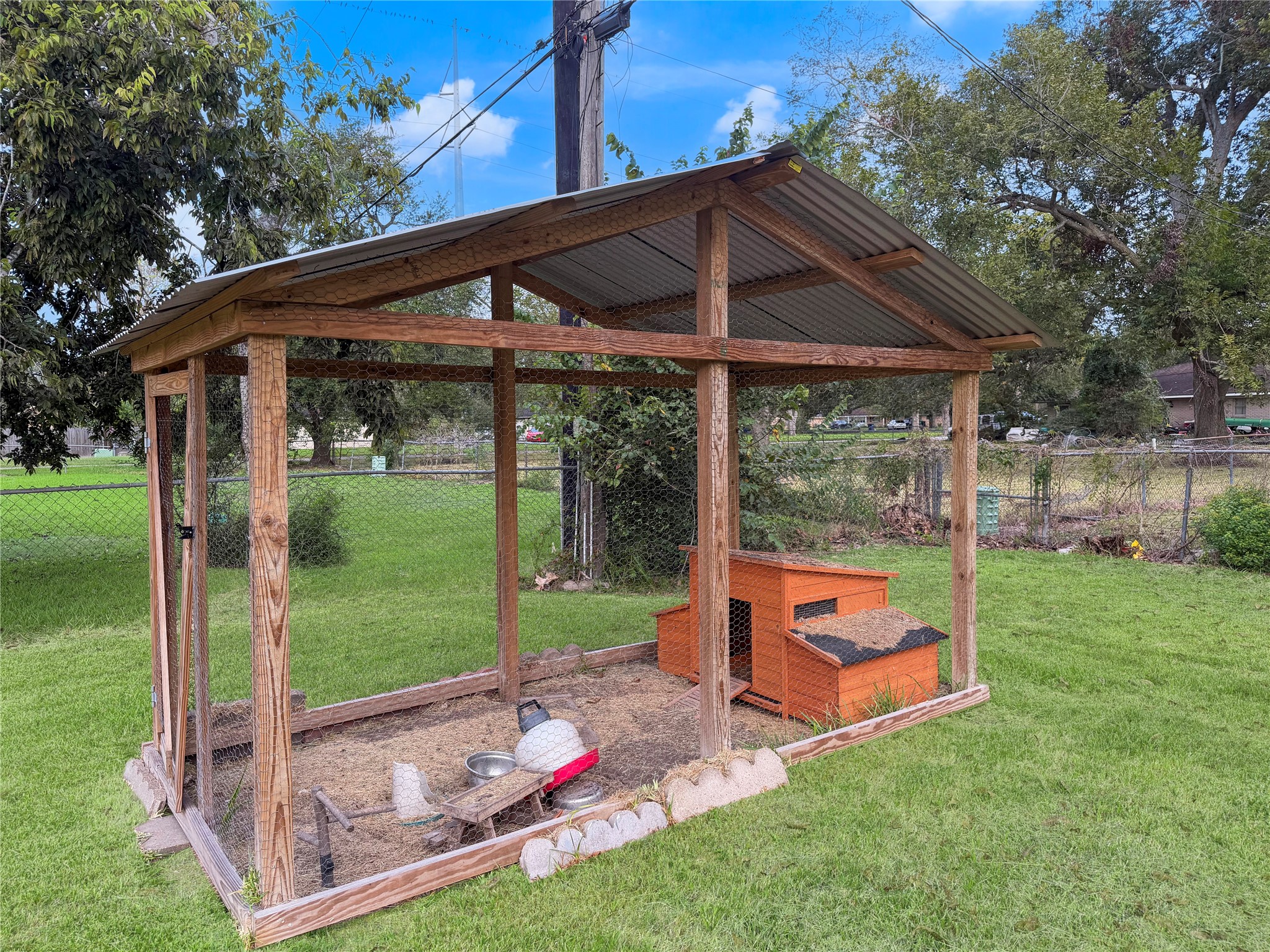Small chicken coop located in the backyard, offering a designated space for keeping chickens or other small-scale backyard farming activities.