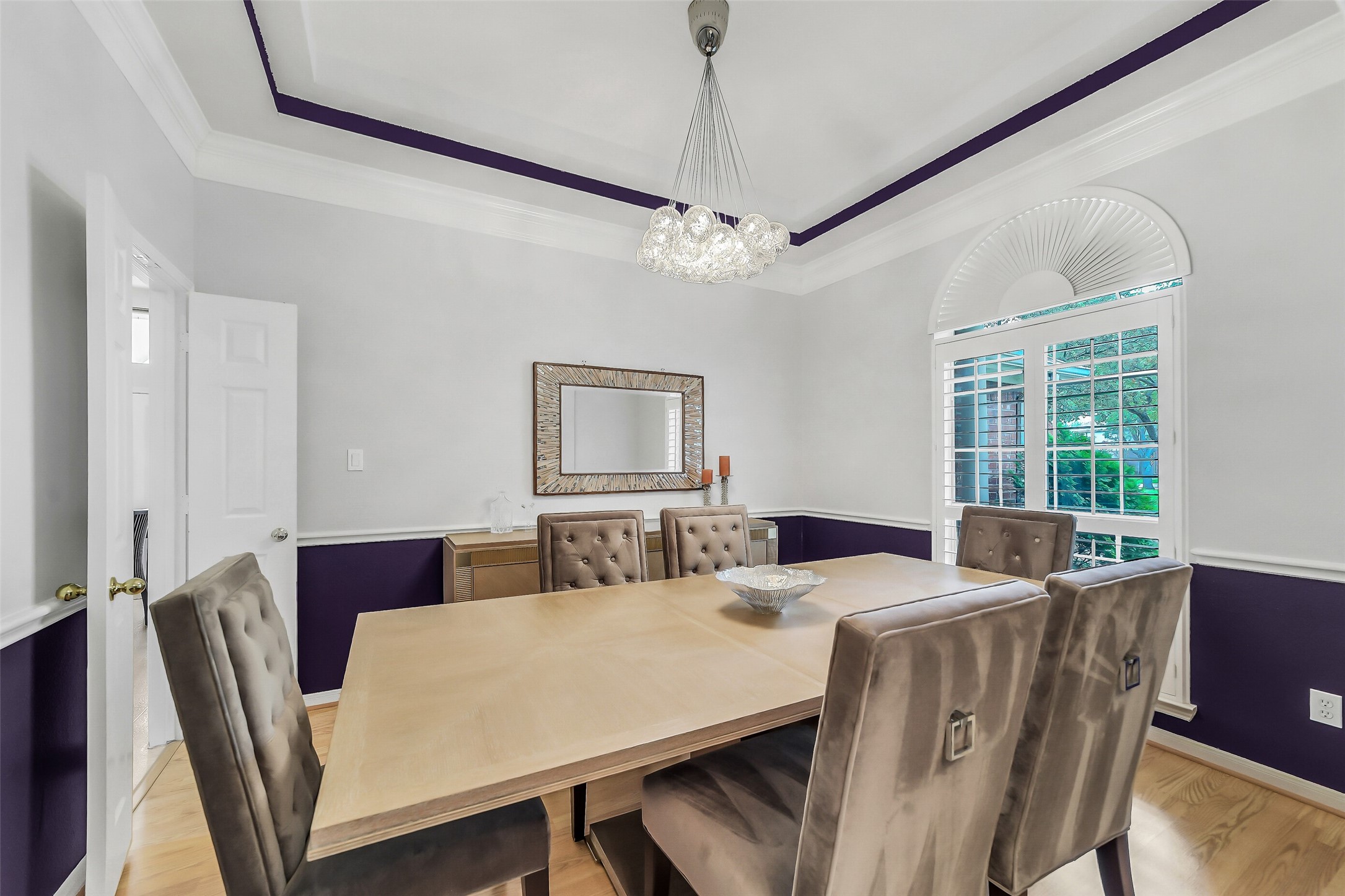 This formal dining room offers the perfect gathering space with tray ceiling and exquisite crown molding that add a touch of sophistication.