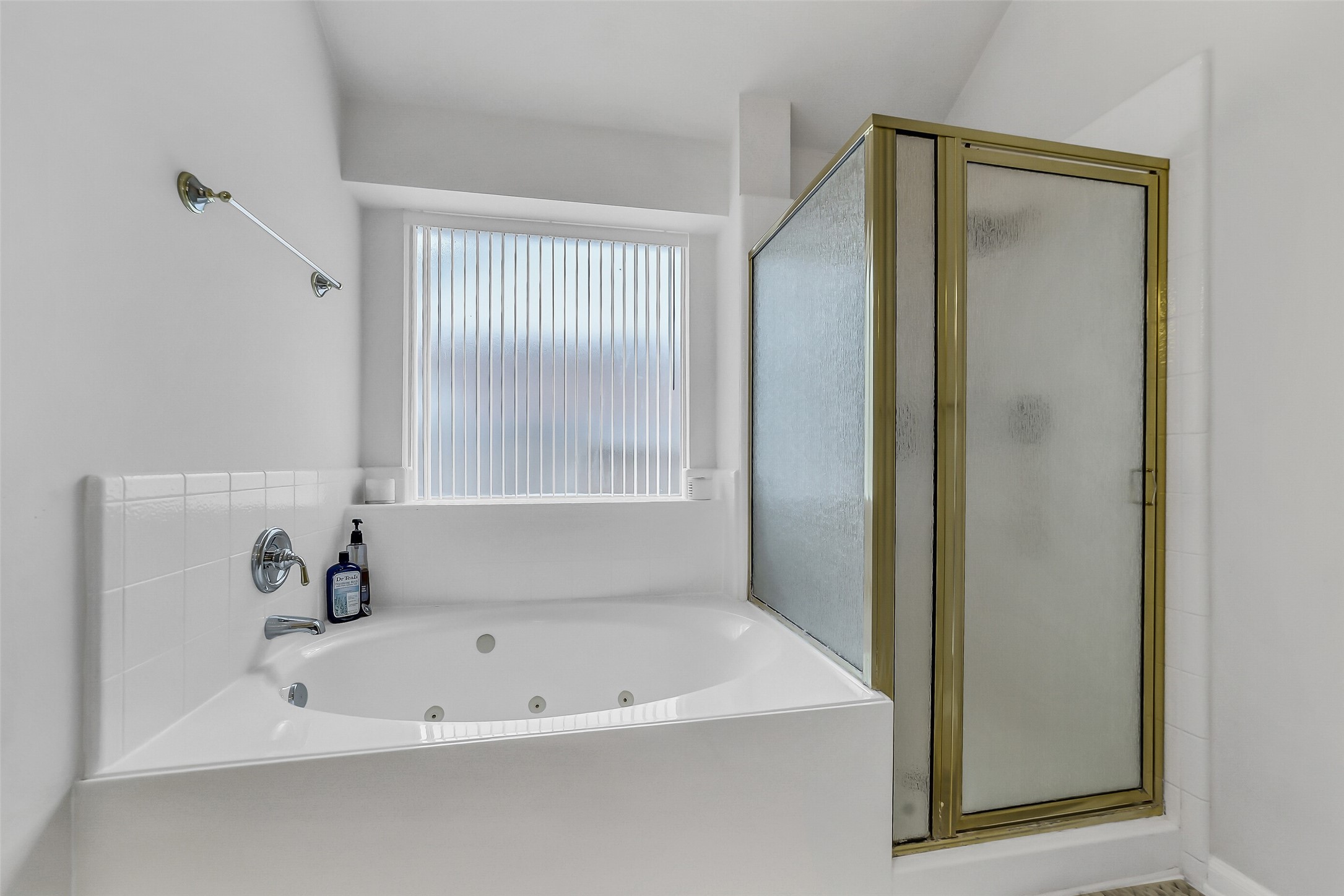 Indulge in spa-like relaxation with a luxurious Jacuzzi tub and a sleek separate shower in the primary bathroom.