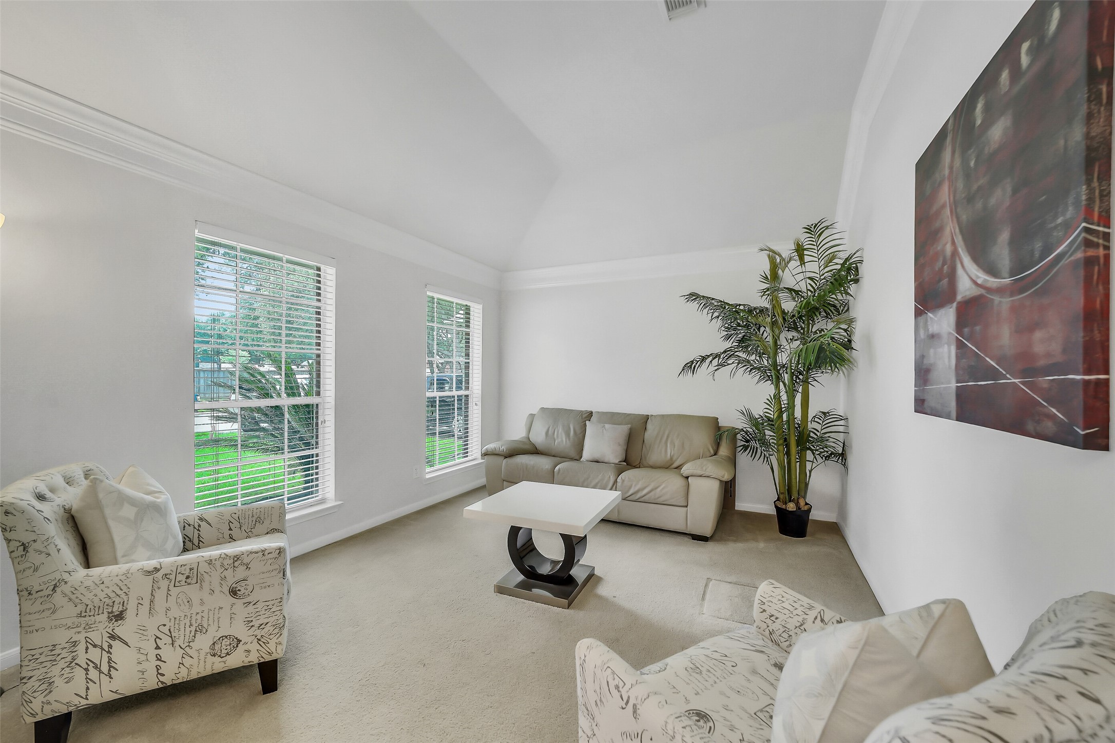 Upon entering, you're greeted by a bright formal living room on the left and an elegant dining area on the right, setting a welcoming and sophisticated tone for the home.