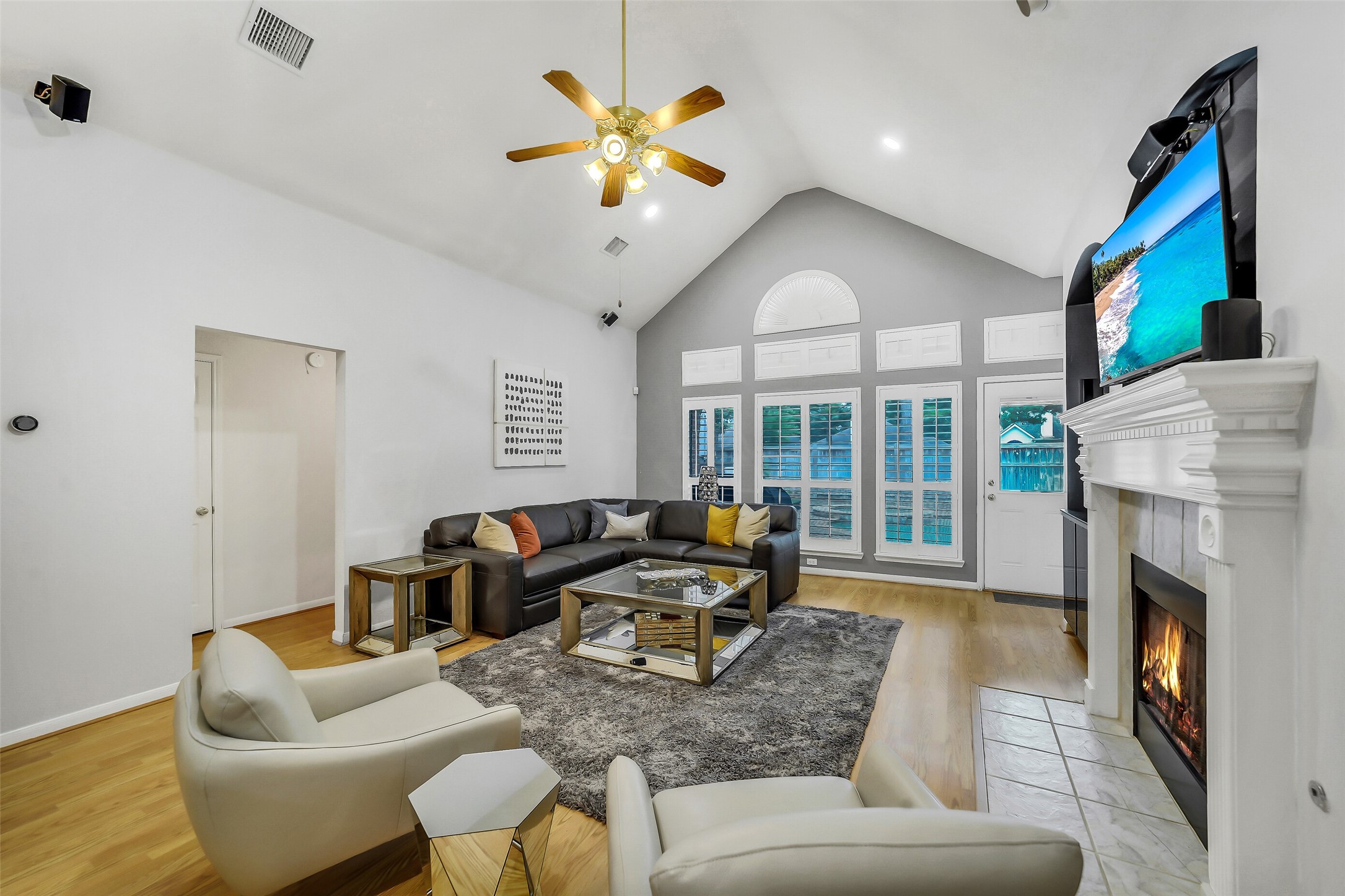 Discover the charm of this expansive family room, where a vaulted ceiling meets a cozy fireplace, creating the perfect blend of space and warmth.