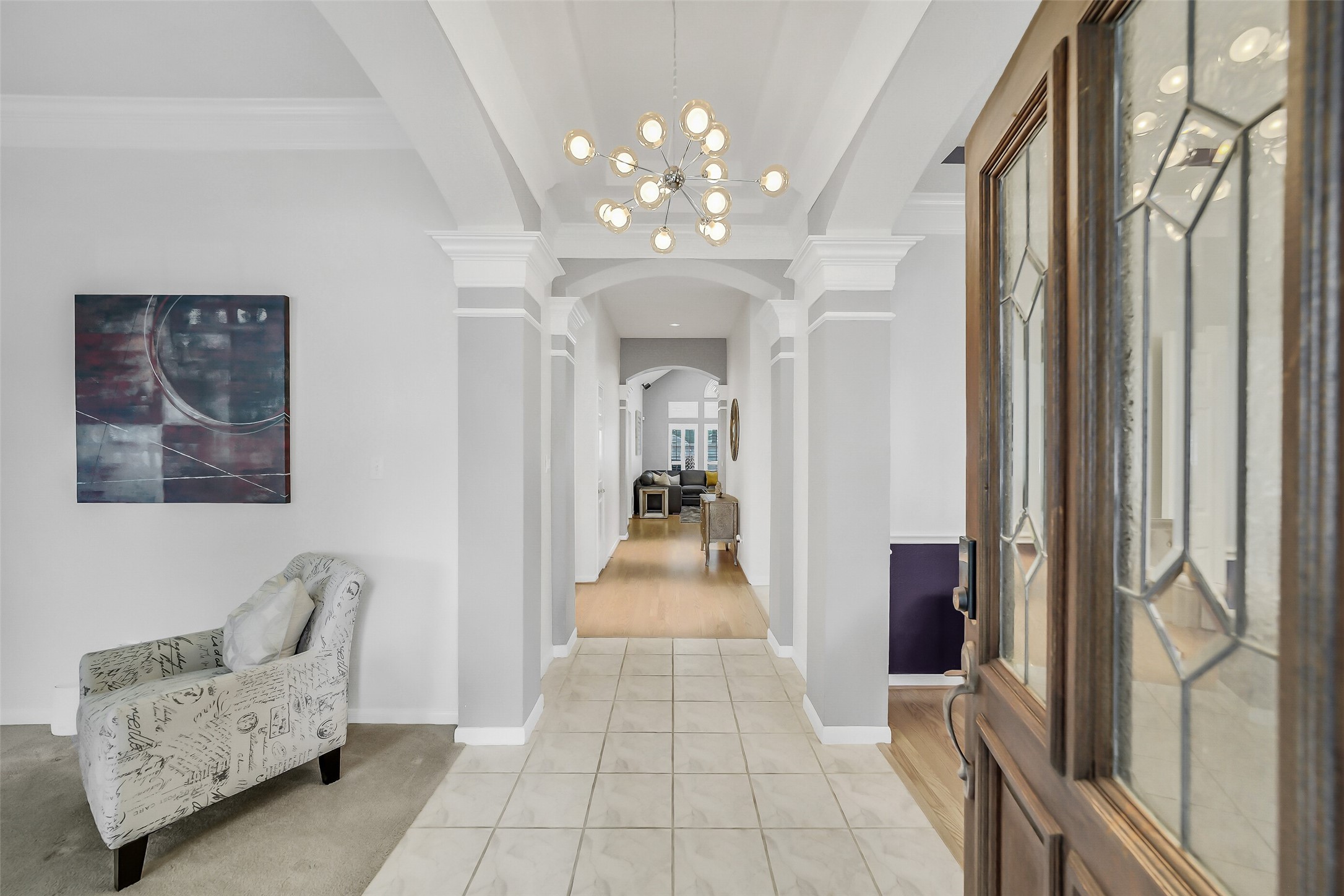 The inviting entrance with leaded glass door  leads to elegant formal spaces and versatile 3 or 4-bedroom living in this captivating home.