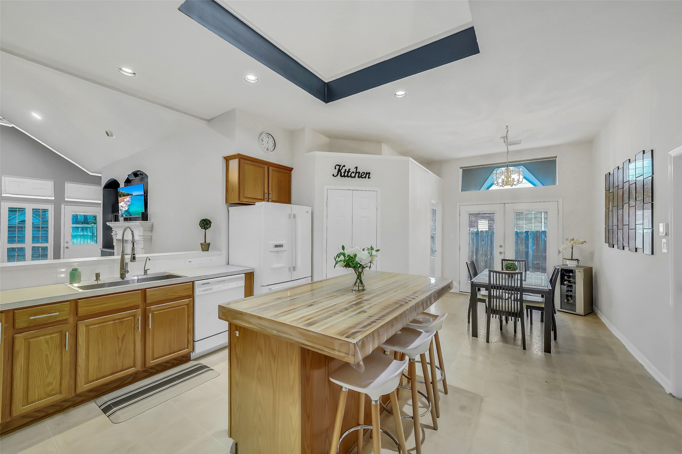The spacious kitchen is bathed in natural light from a skylight, featuring a custom island and ample counter space for all your culinary adventures.