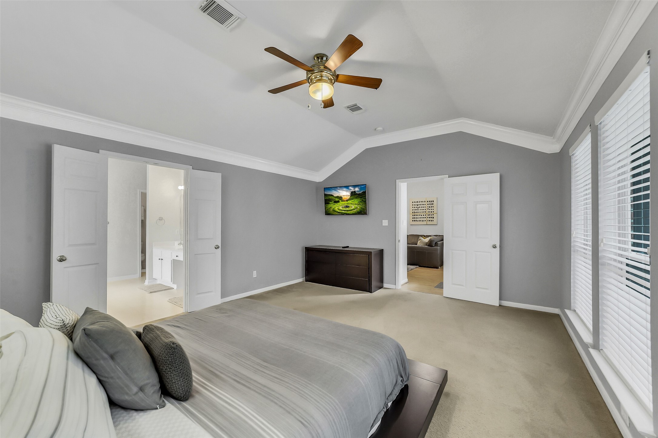 Primary bedroom features tray ceiling, ceiling fan, and en-suite bathroom.