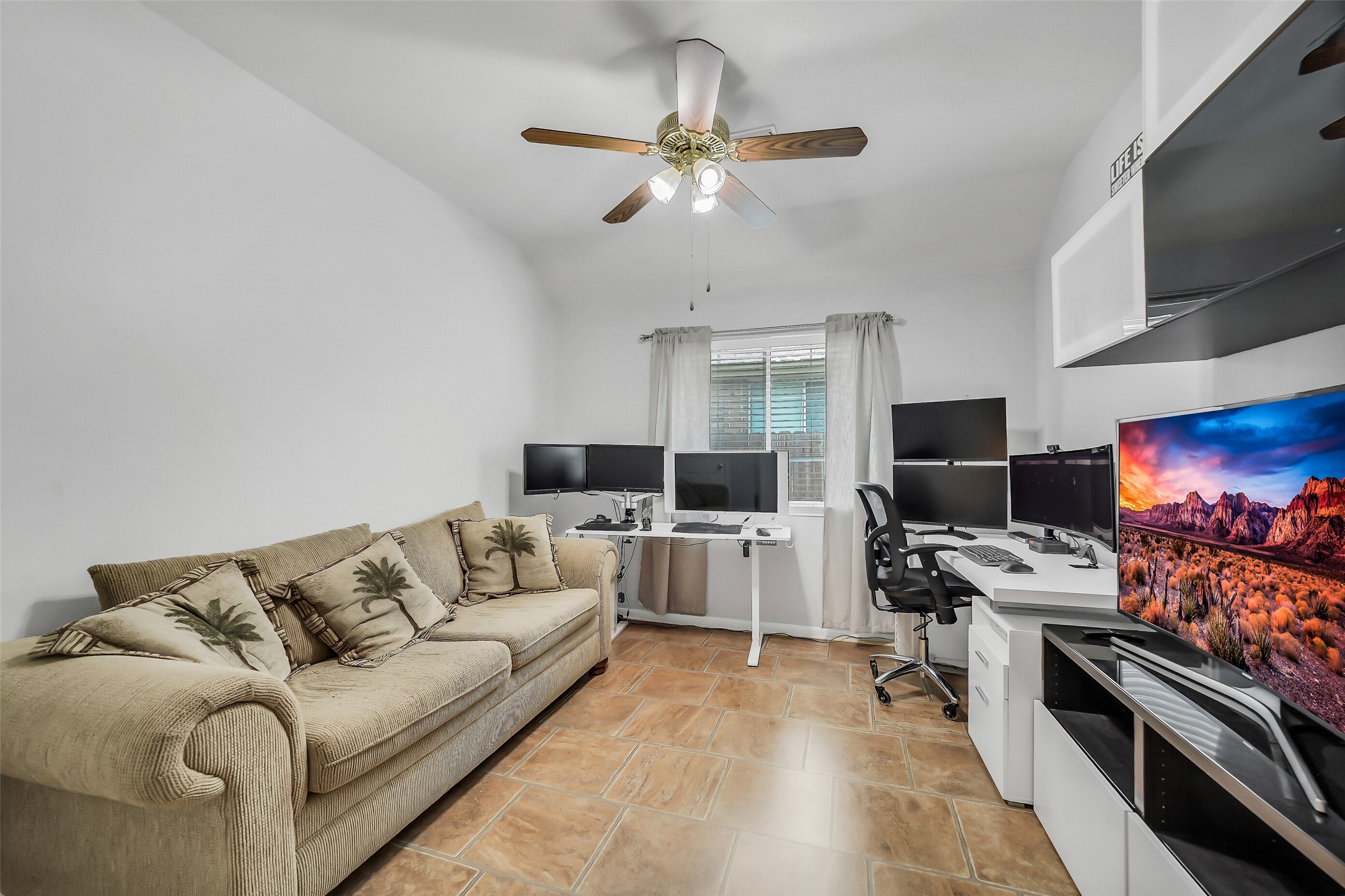This versatile room, featuring a ceiling fan, offers the perfect space for an office, a fourth bedroom, or a lively game room, catering to your lifestyle needs.