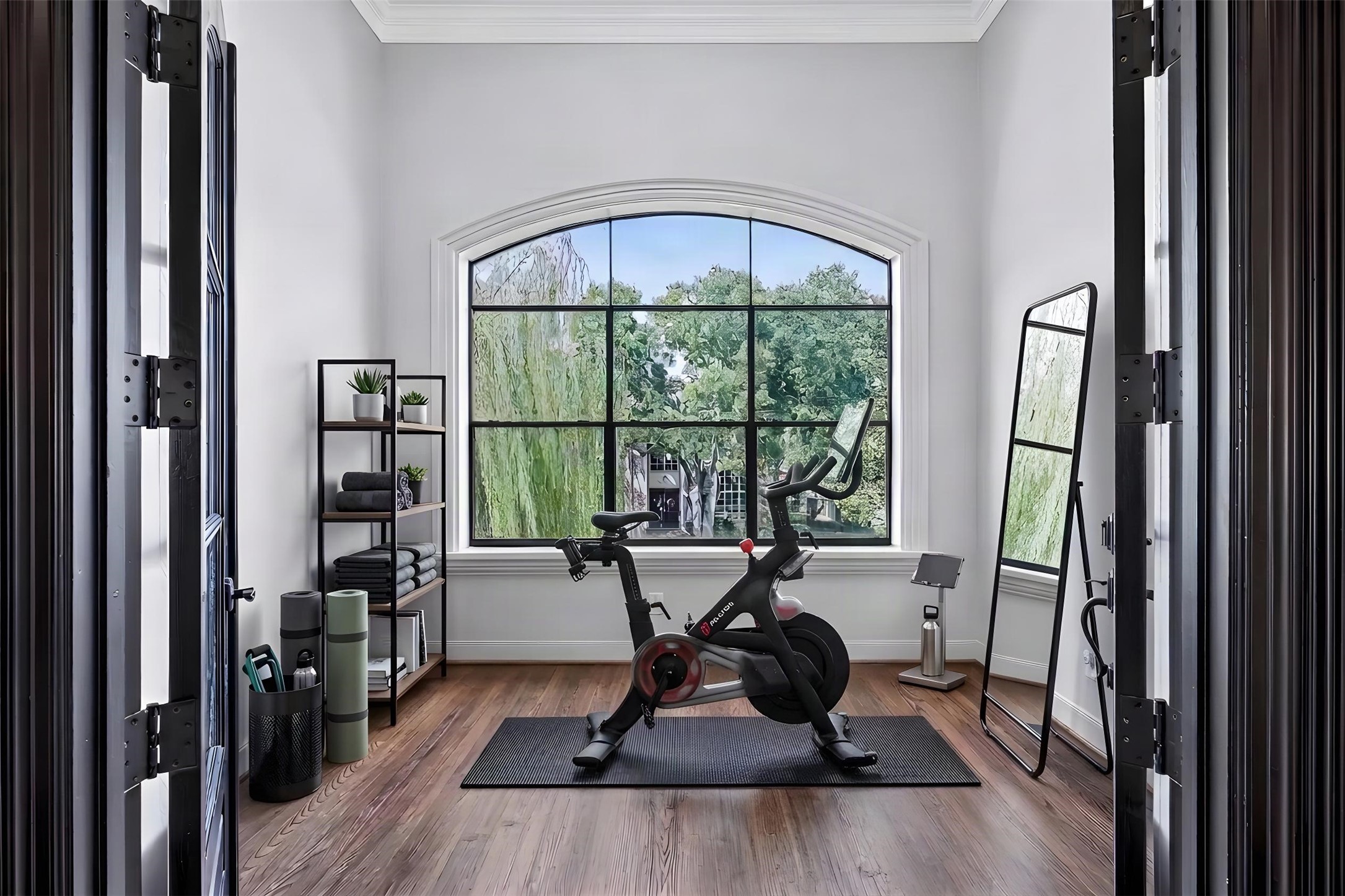 Inside the sunroom, it is bright and inviting. The space is imagined as a home gym or yoga room.