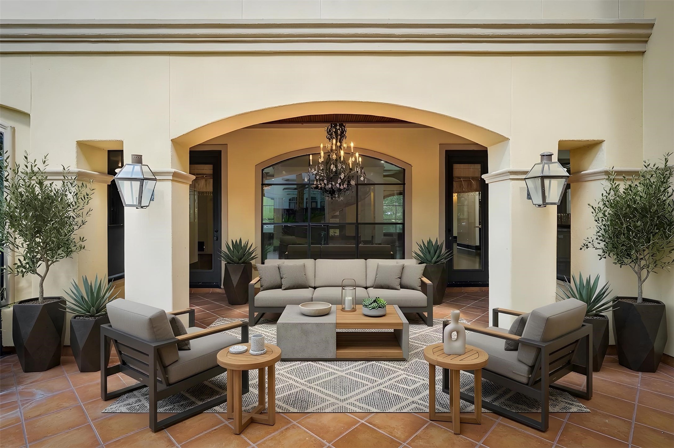 Directly back to the home is a covered patio that continues the arched-themed windows and doorways. *Photo is virtually staged*
