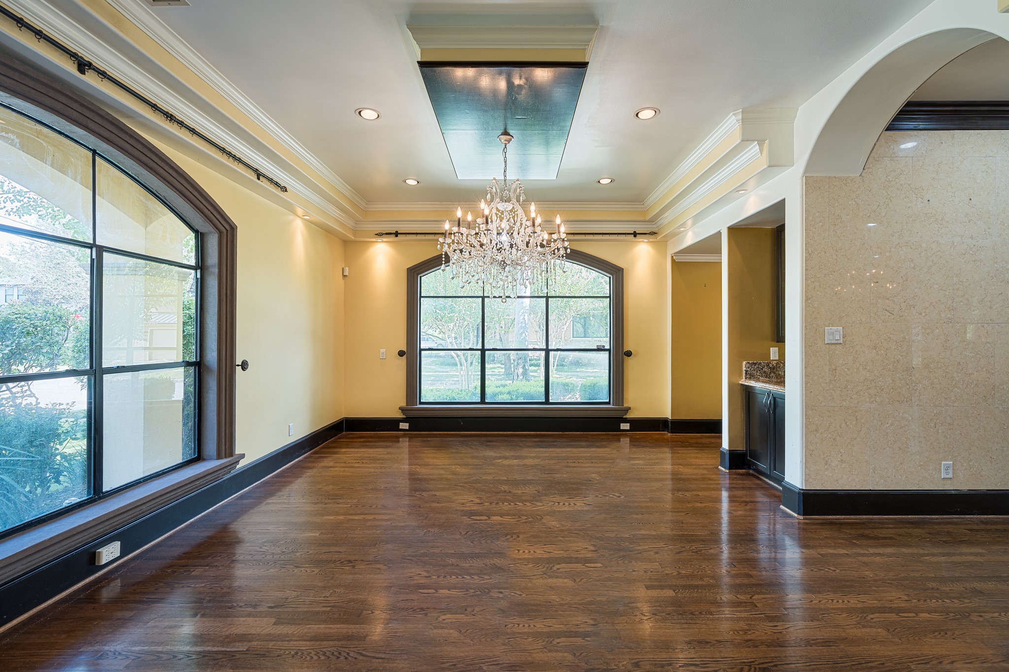 Separate view of dining room shows a dry bar and a recessed section for a china cabinet or buffet table