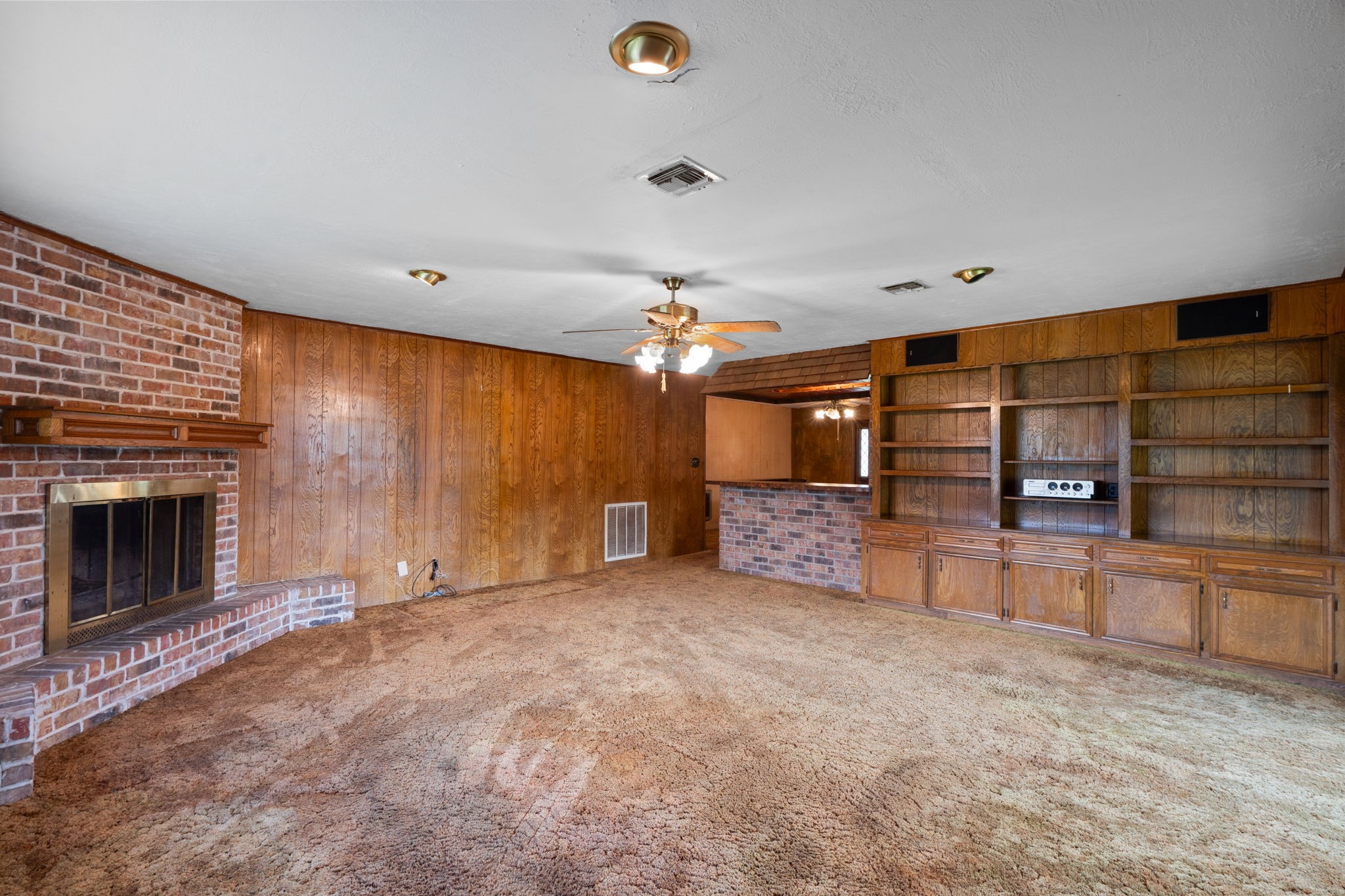 Built-in shelving, cabinetry, and brick fireplace. Built-in shelving, cabinetry, and brick fireplace.
