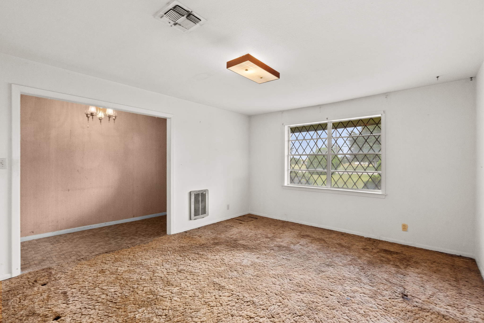 Additional view of the living room and adjoining dining area. Additional view of the living room and adjoining dining area.