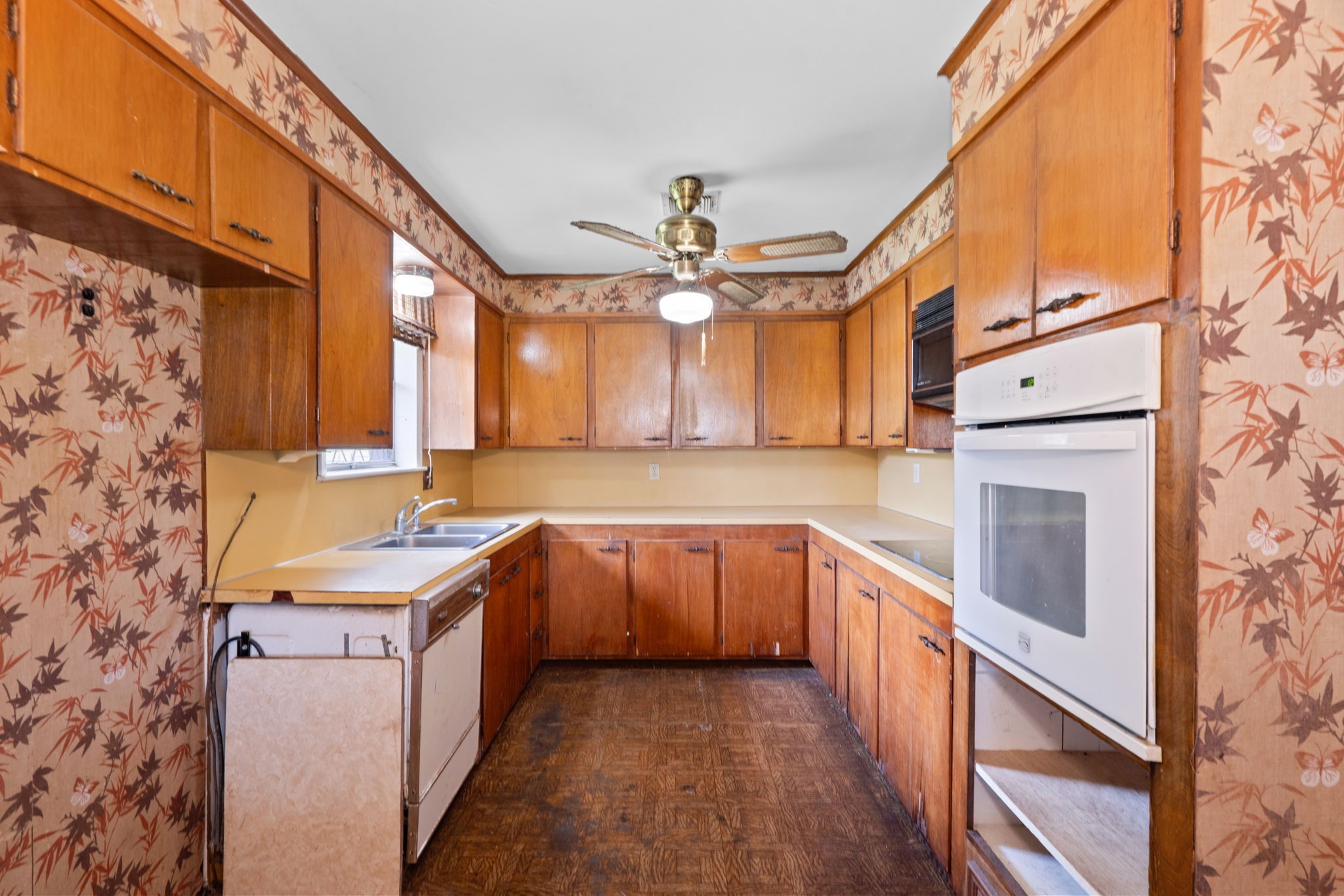 U-shaped kitchen with extensive cabinetry and built-in oven.