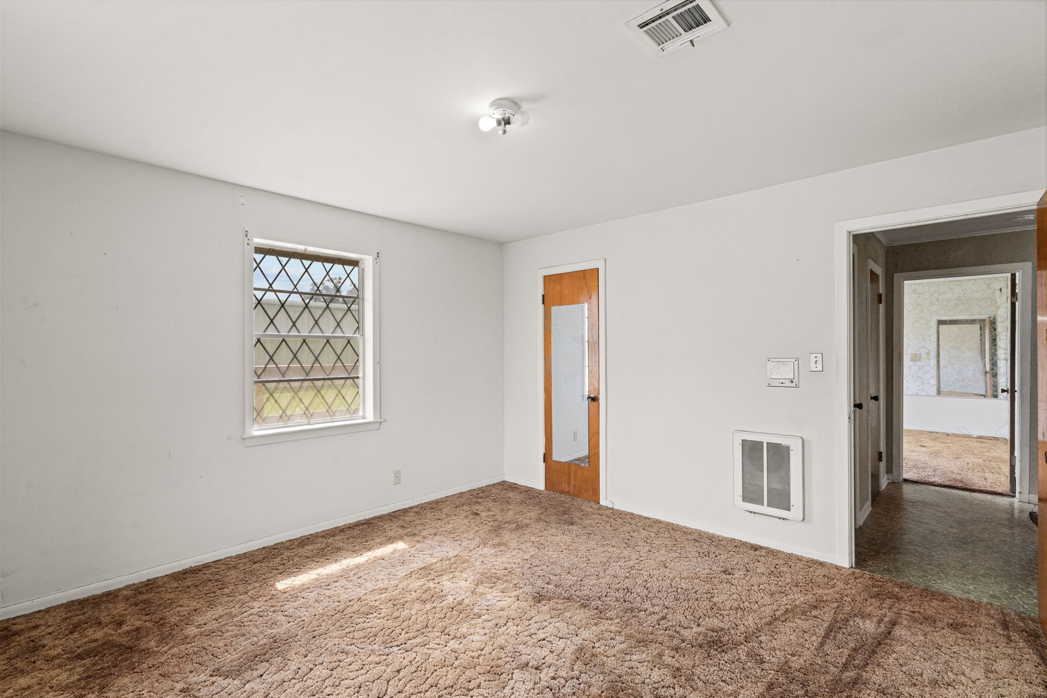Additional bedroom view showing closet and hallway access.