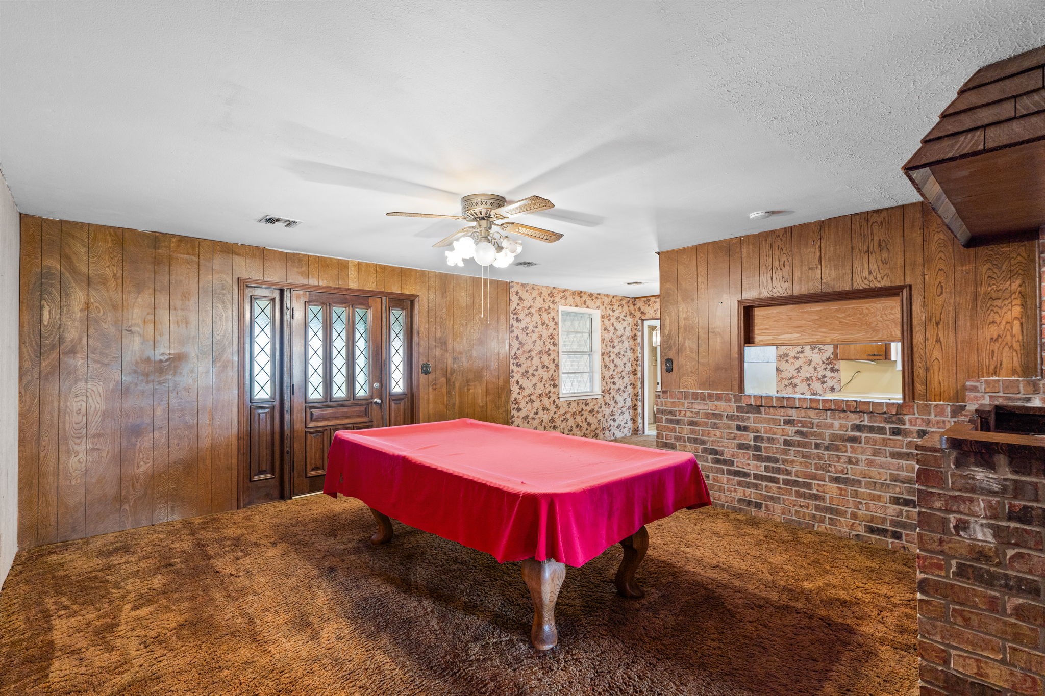 Entertainment/living space with wood paneling and custom wet bar. Entertainment/living space with wood paneling and custom wet bar.